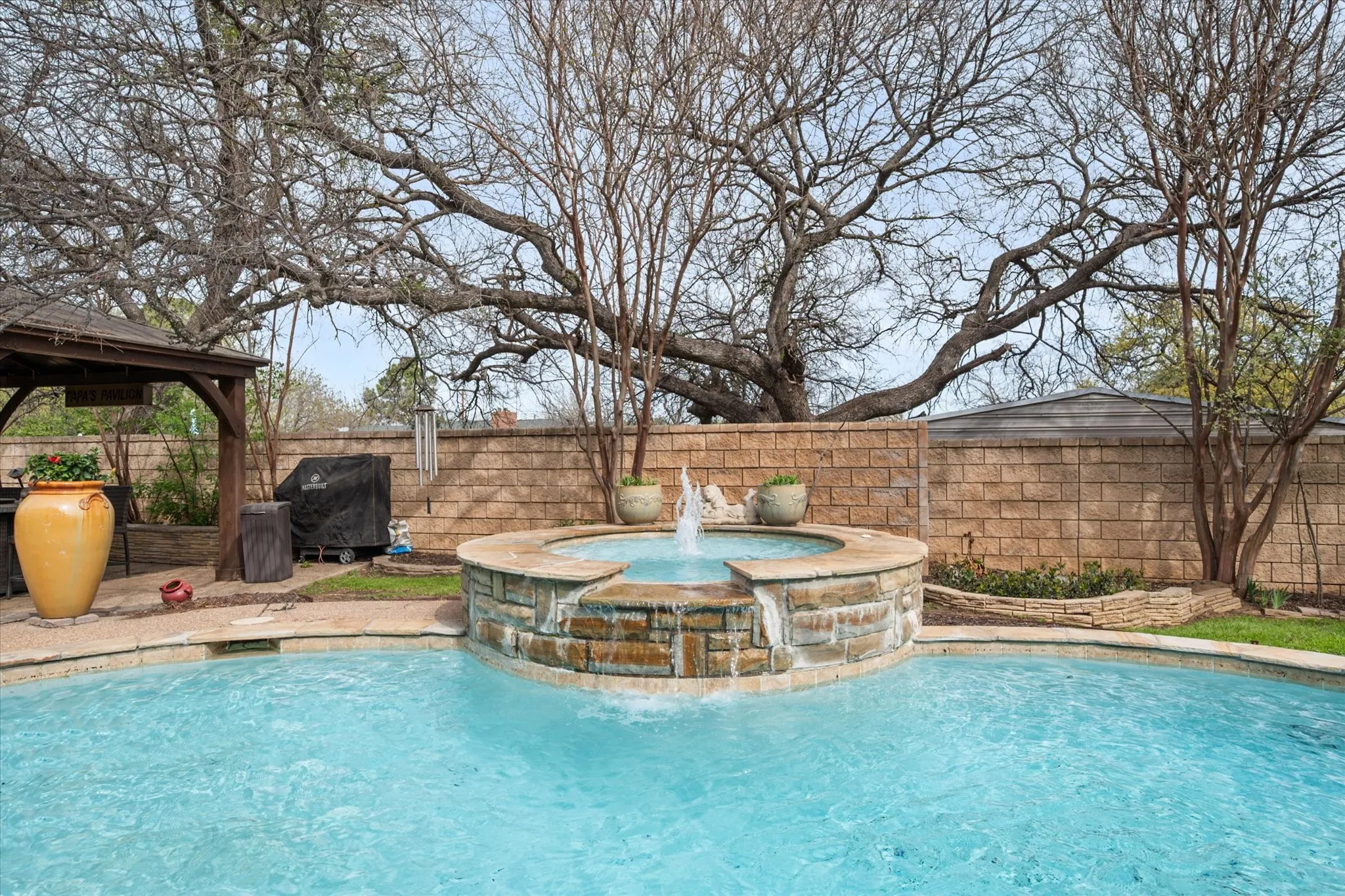 Combined pool / hot tub featuring a patio, a fenced backyard, area for grilling, and a gazebo