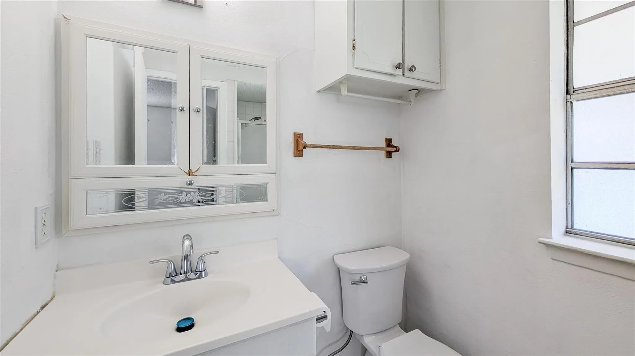 Bathroom featuring vanity and a shower