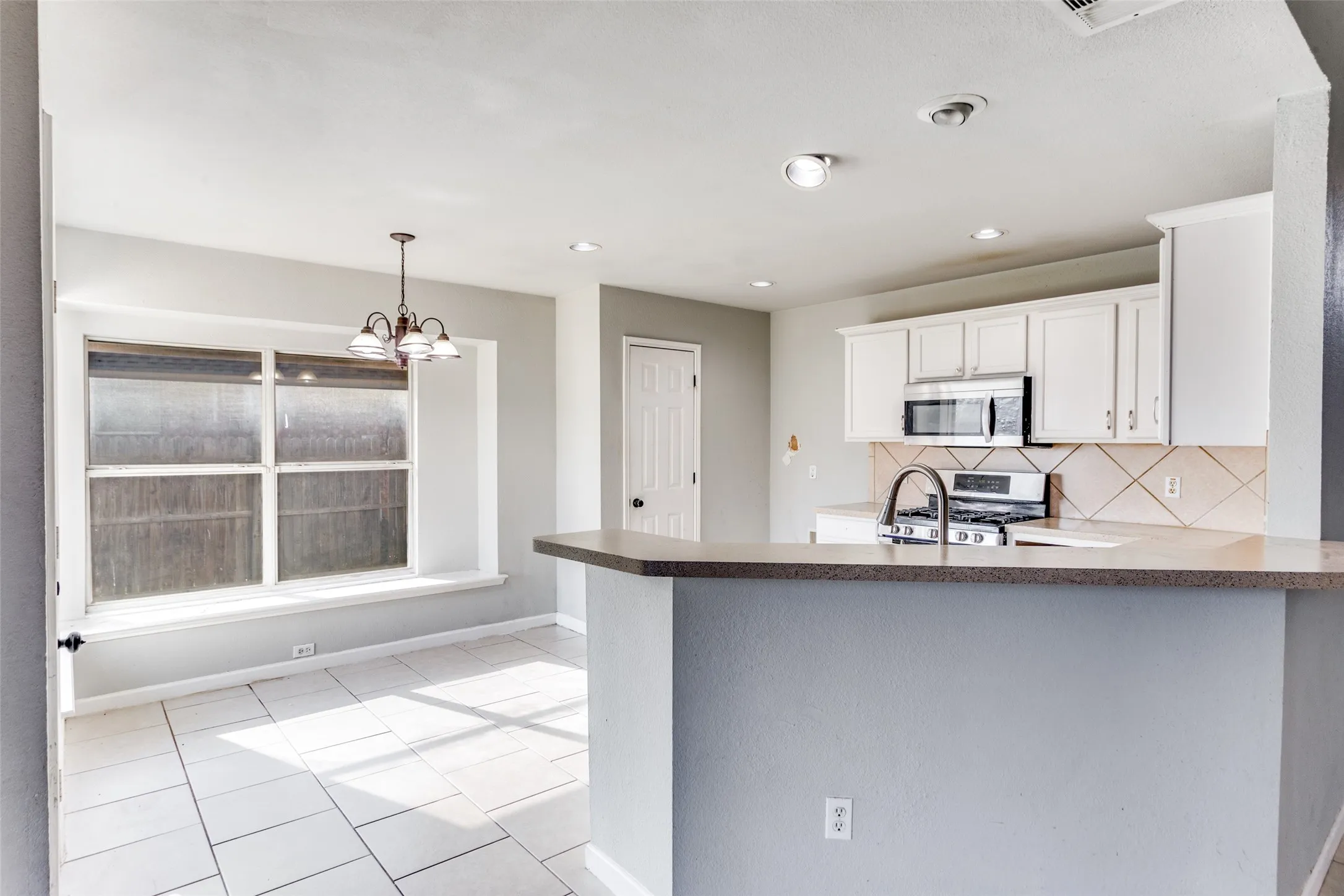 The open kitchen features a spacious dining area with plenty of windows for natural light.  Notice the window seat!