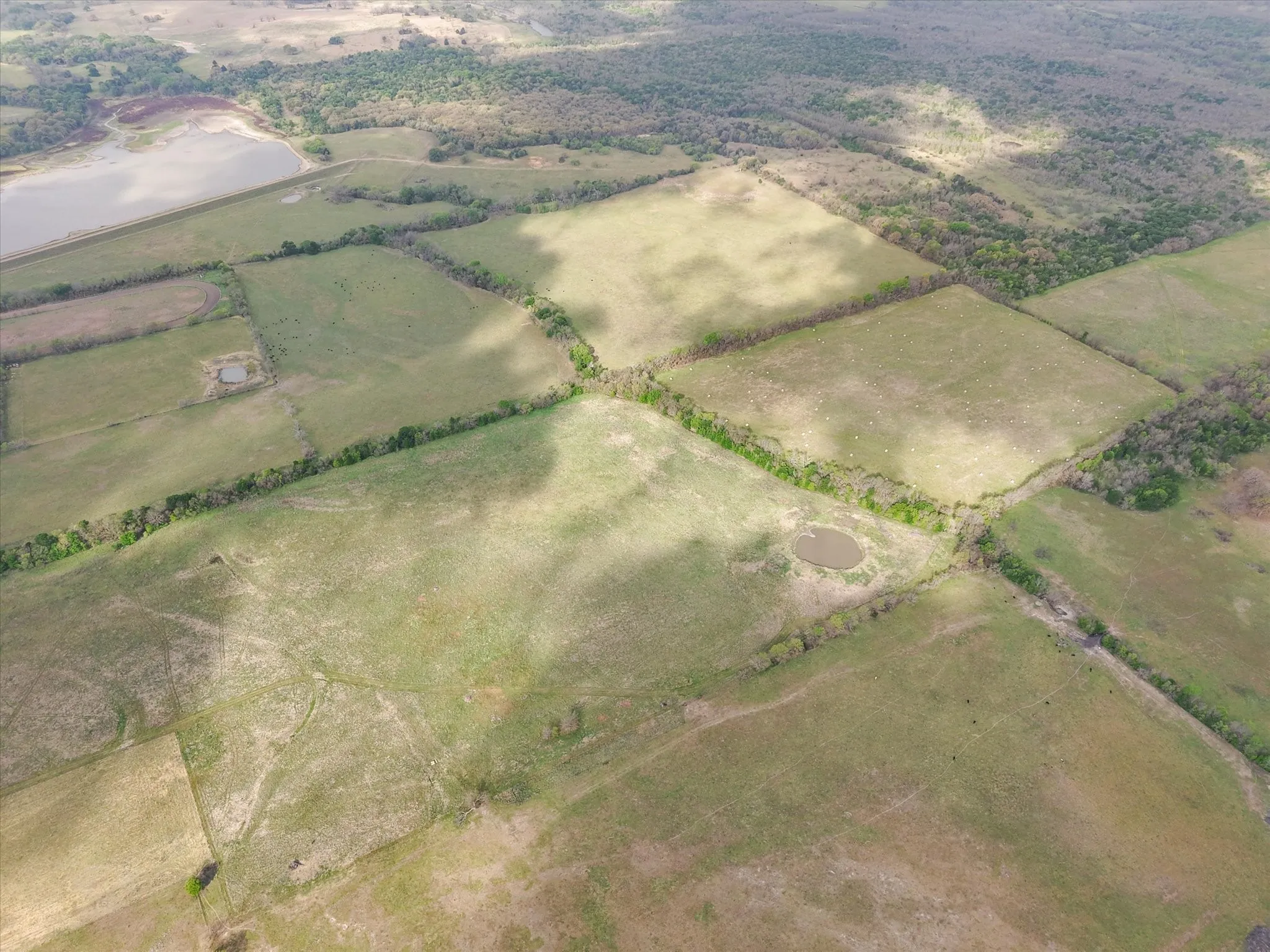 Aerial view of sparsely populated area with large plots for crops