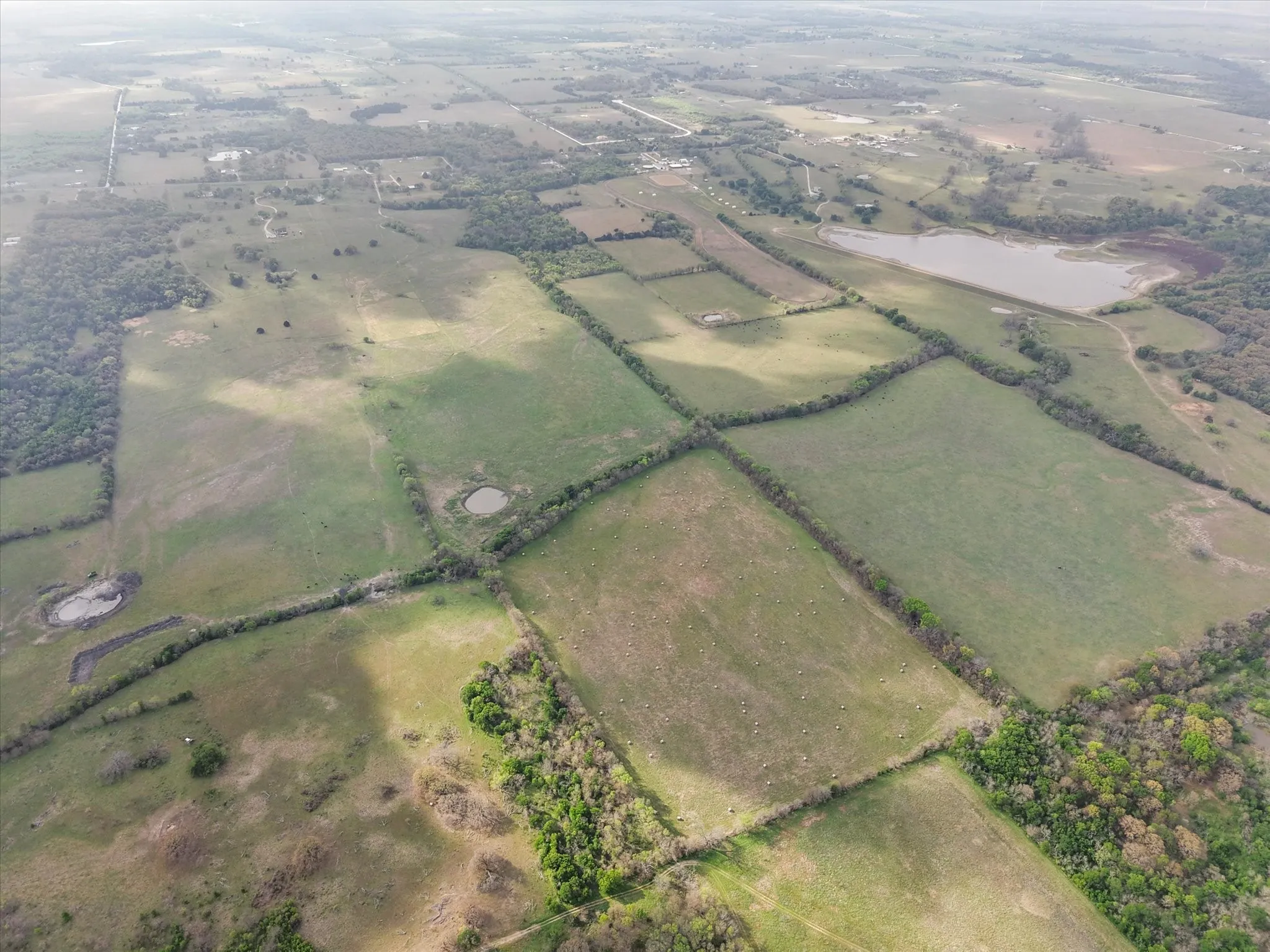 Aerial view of property's location with rural landscape and large plots for crops