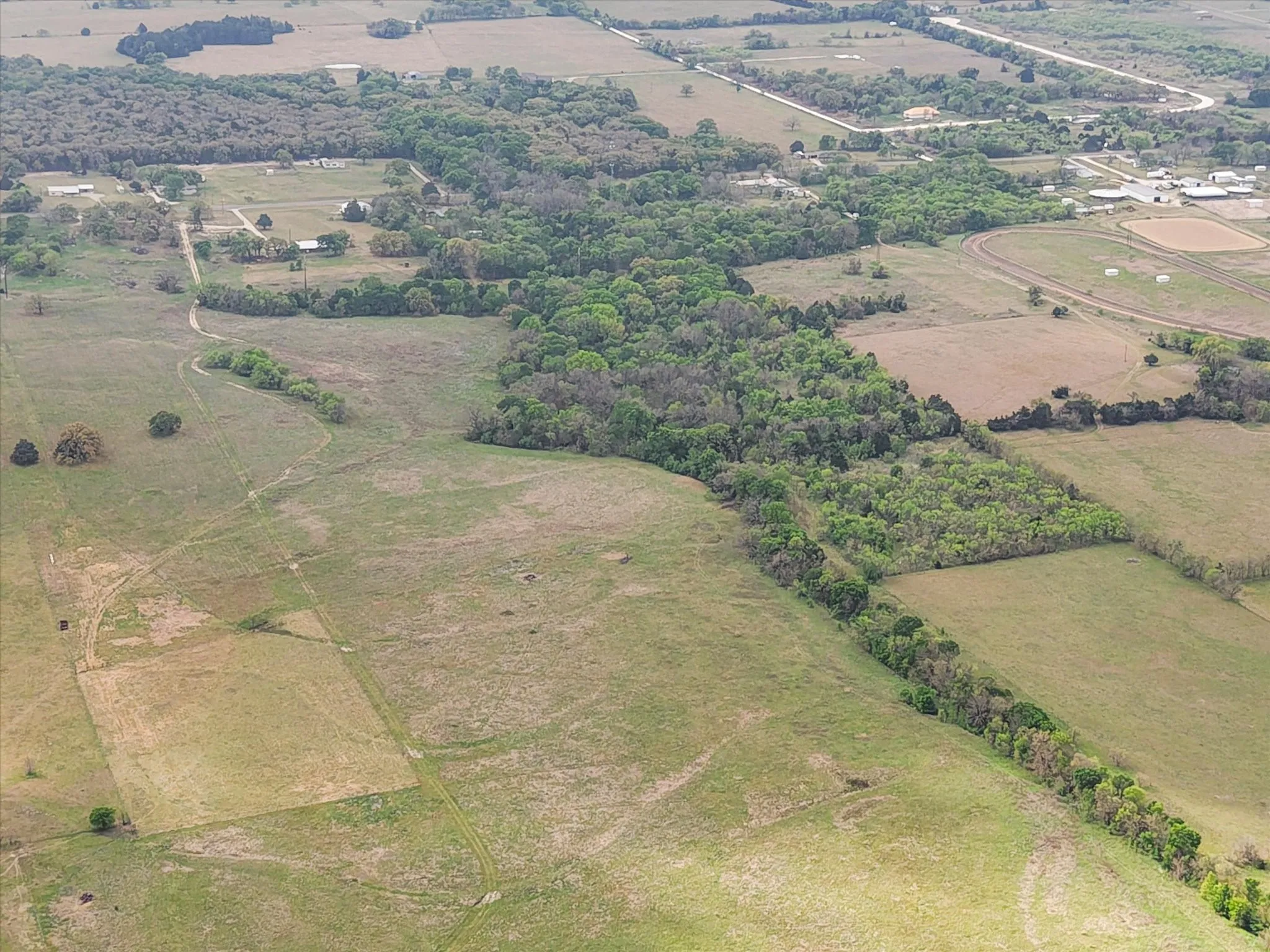 Aerial view of property and surrounding area with rural landscape and large plots for crops