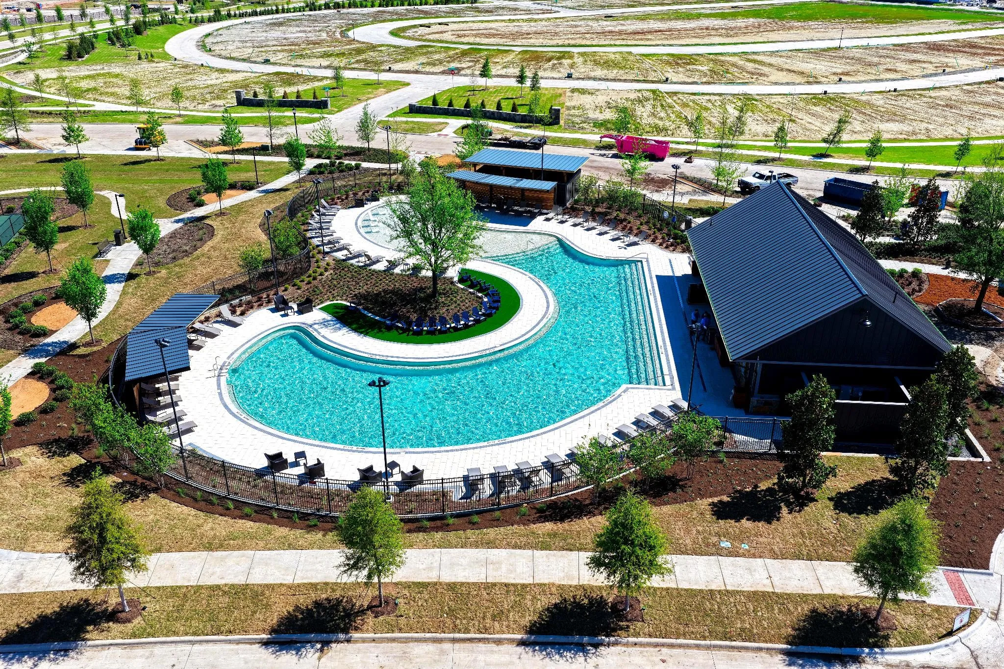 Resort-style pool with integrated sun ledges and a central landscaped island
