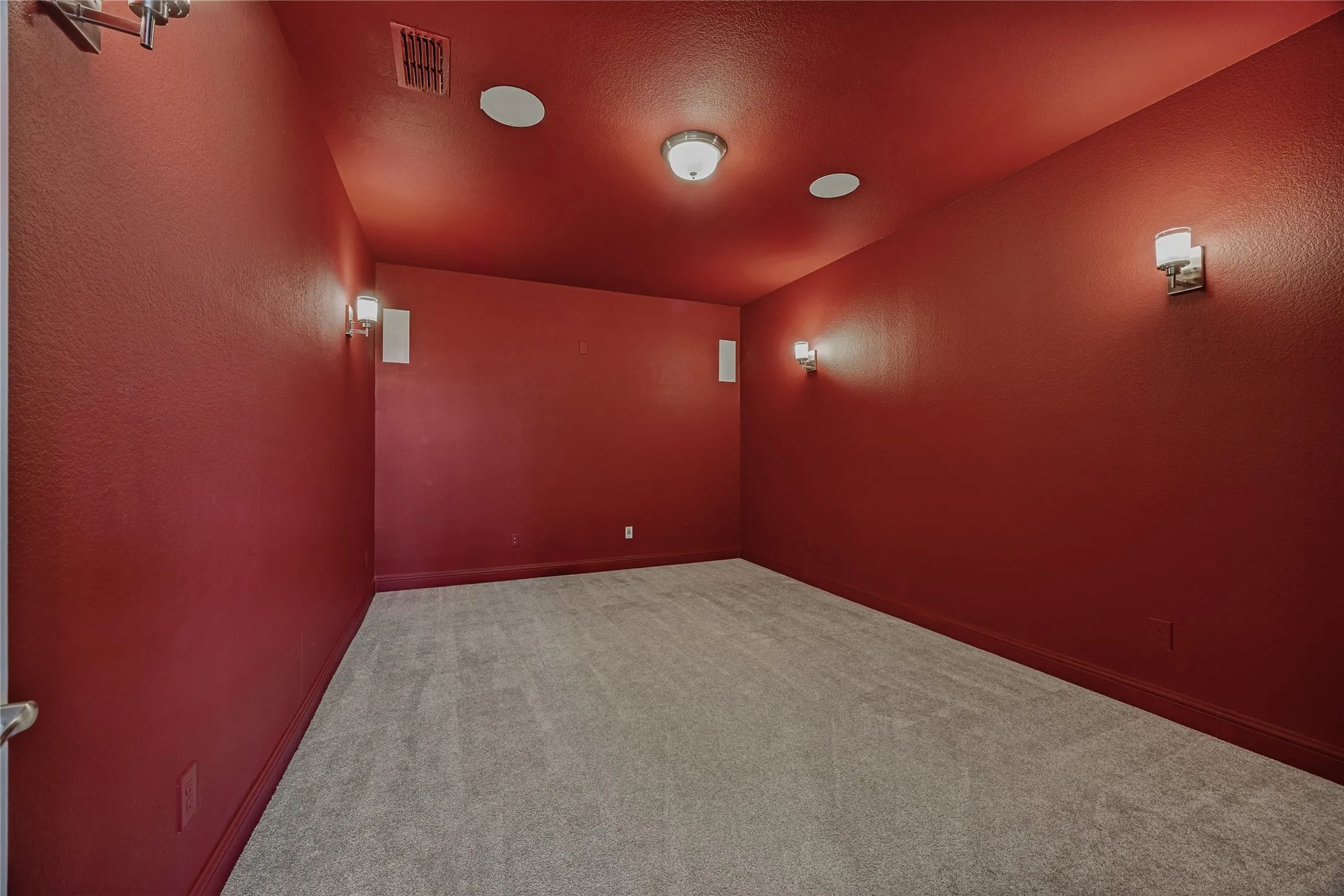 Dedicated room featuring deep red walls and a matching ceiling