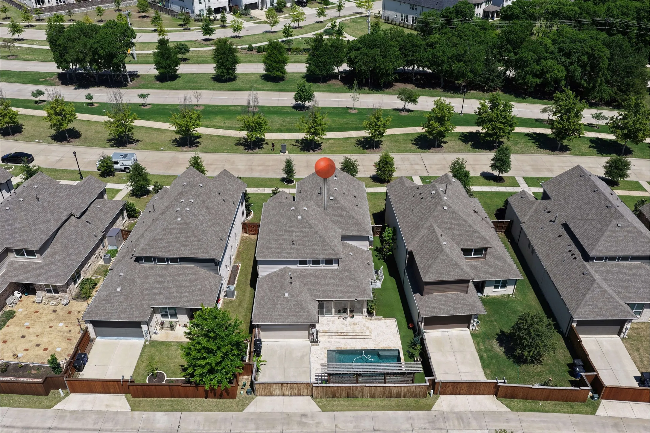 Property featuring a private backyard with an in-ground swimming pool, adjacent paved patio, and a wood fence enclosure