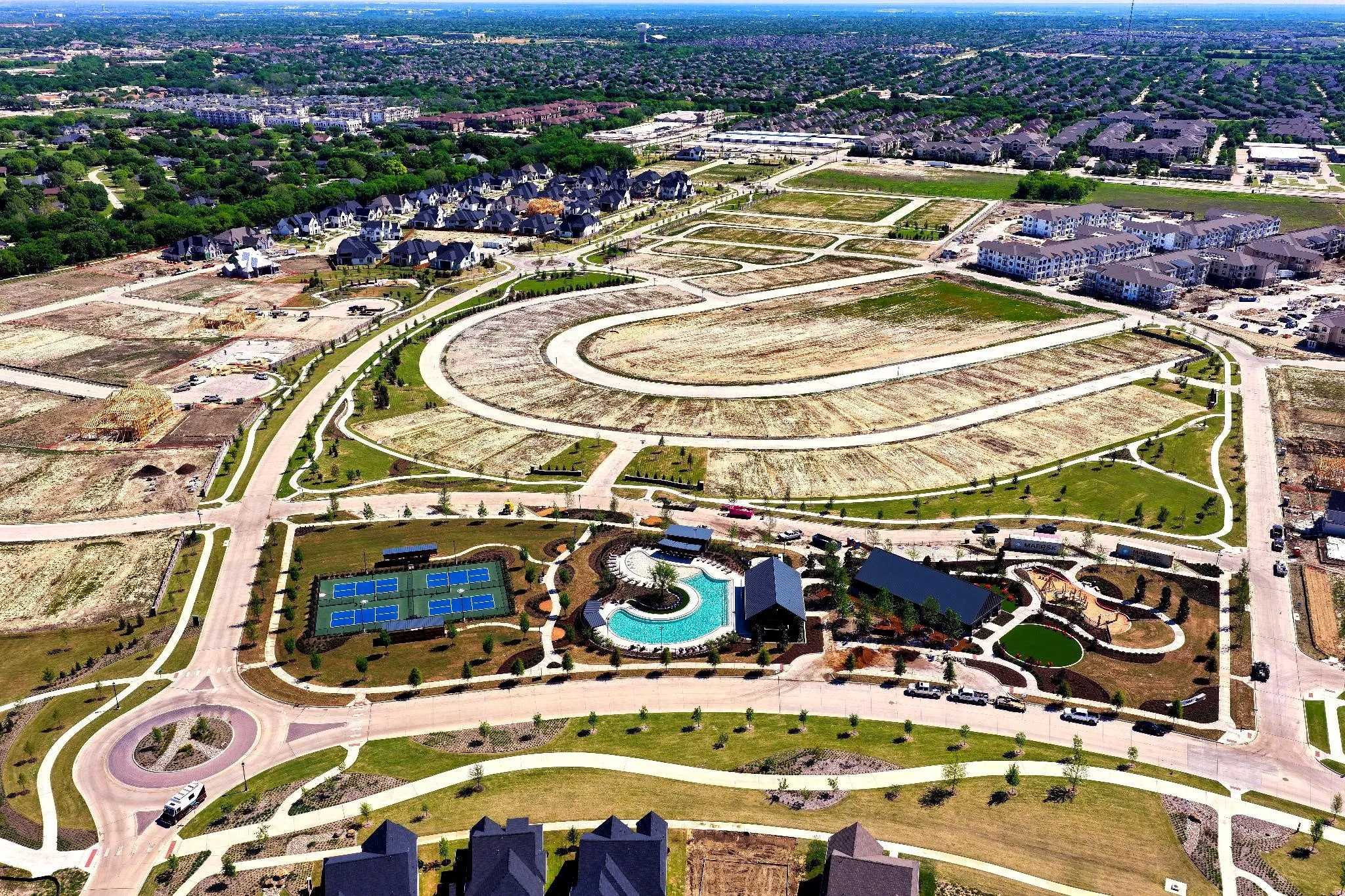 Aerial perspective showcasing a developing community with varied residential plots