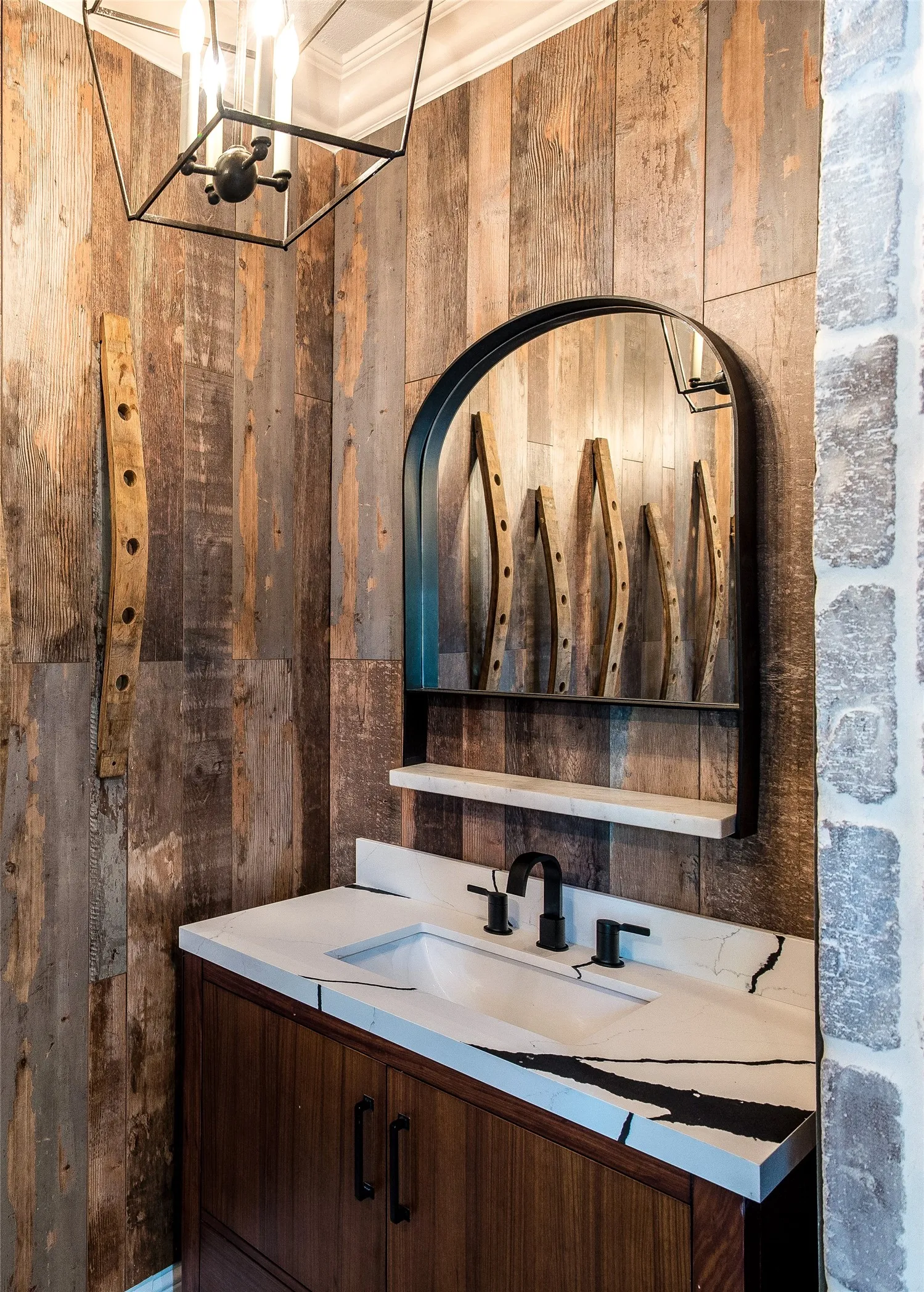 Bathroom with wood walls, vanity, crown molding, and a shower