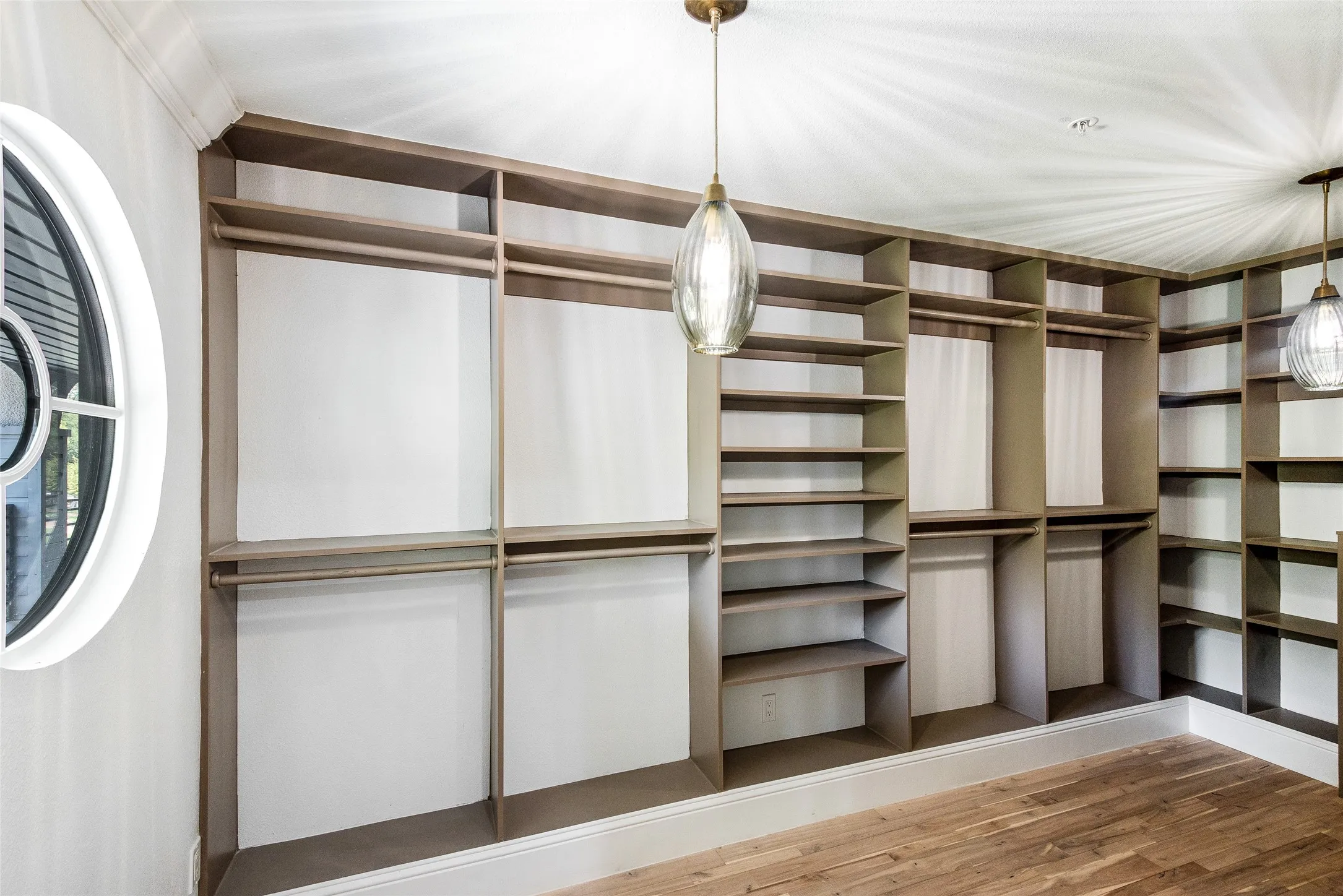 Walk in closet featuring wood finished floors