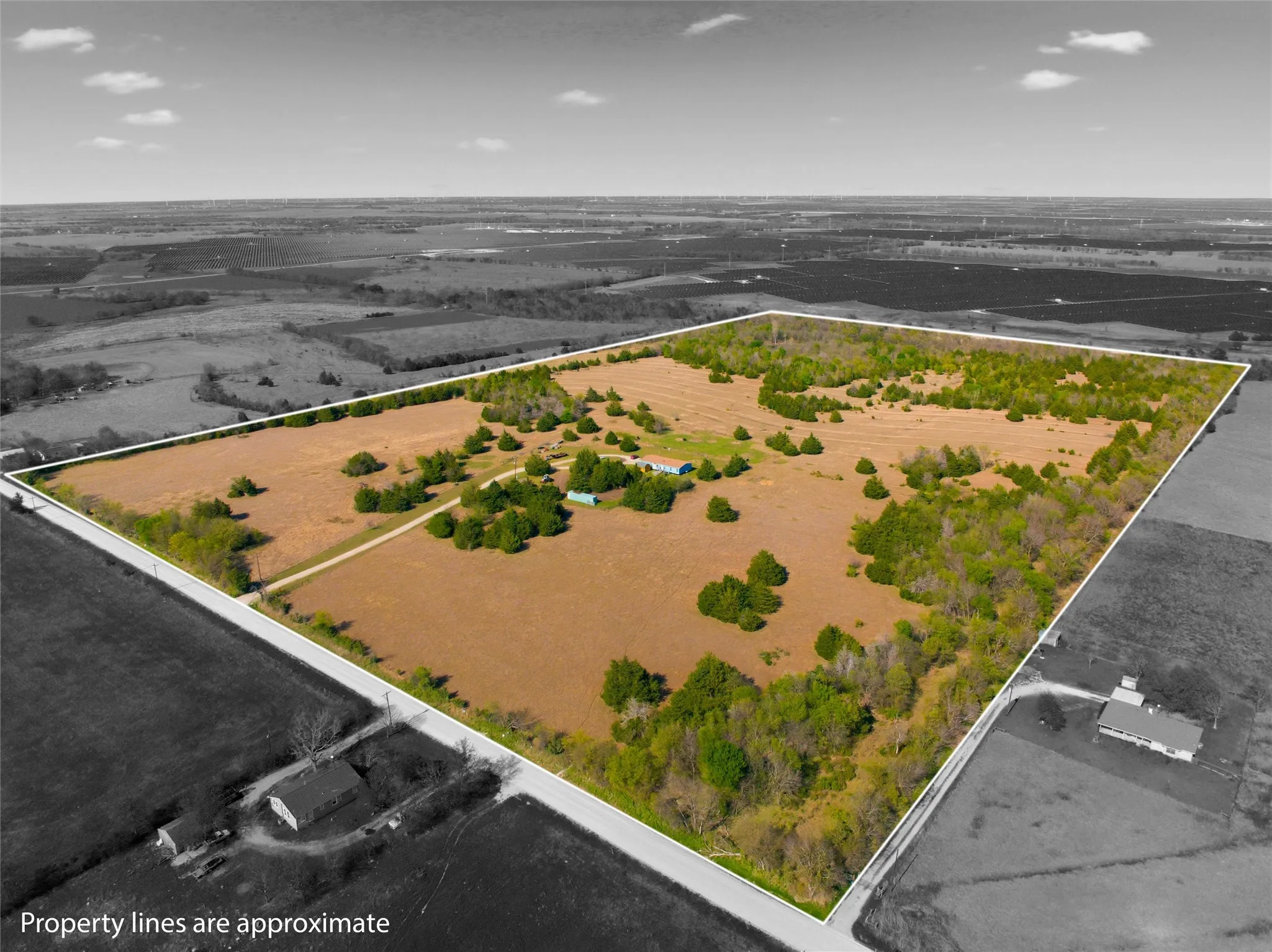 Aerial view of sparsely populated area with property parcel outlined