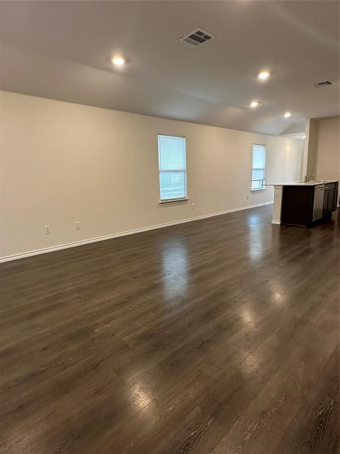 Spare room featuring dark wood-style floors and recessed lighting