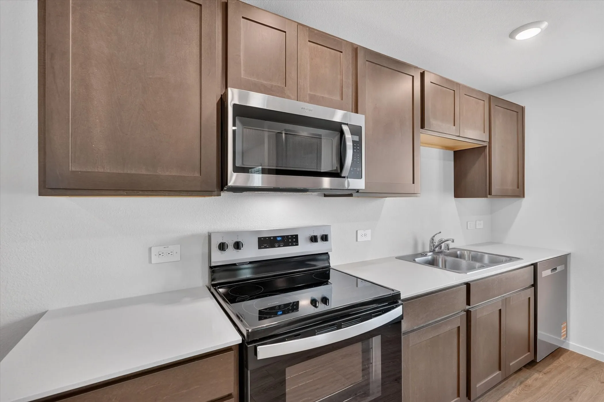 Wood-finish cabinetry paired with white countertops