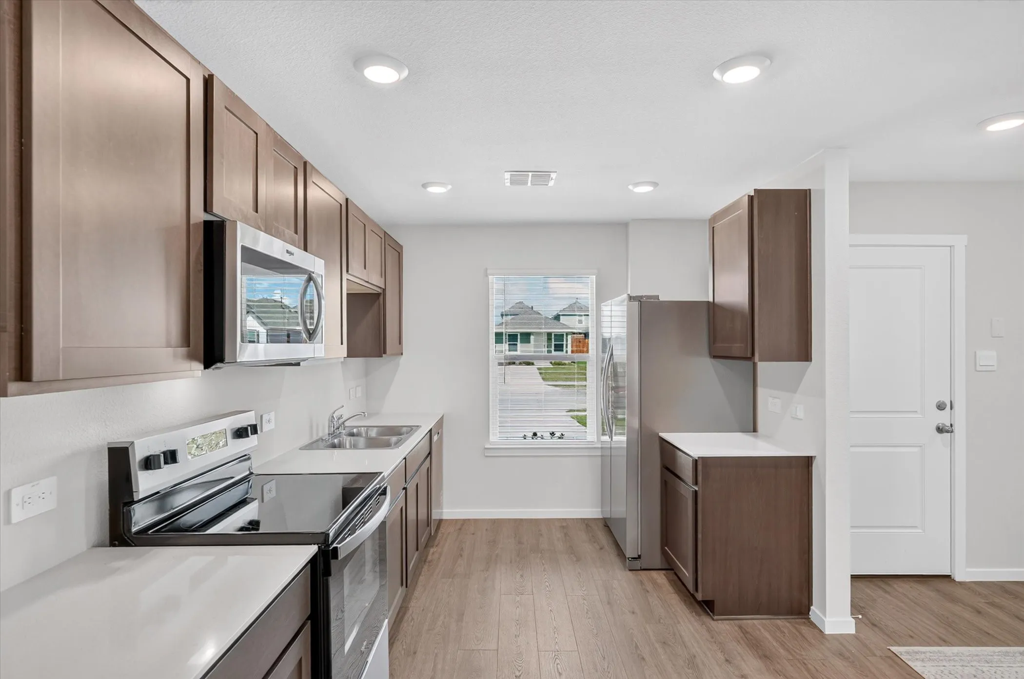 Kitchen featuring wood-finish flooring, recessed lighting, and stainless steel appliances