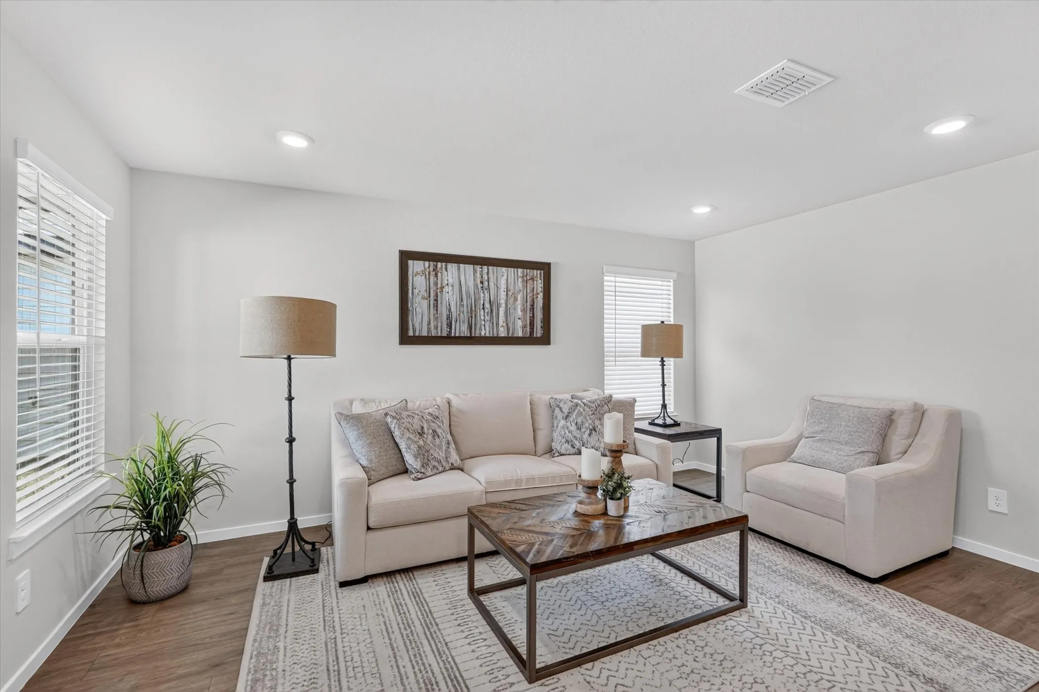 Recessed ceiling lighting, wood-finish flooring, white window blinds, and light-toned walls