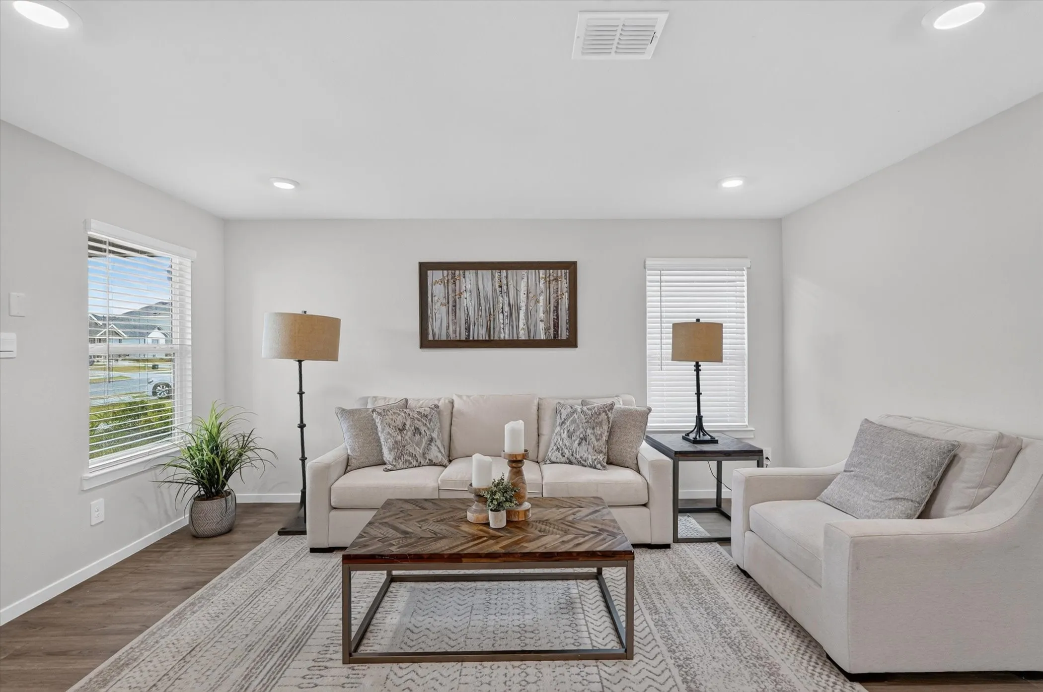 Recessed ceiling lighting, wood-finish flooring, white walls, and white window blinds