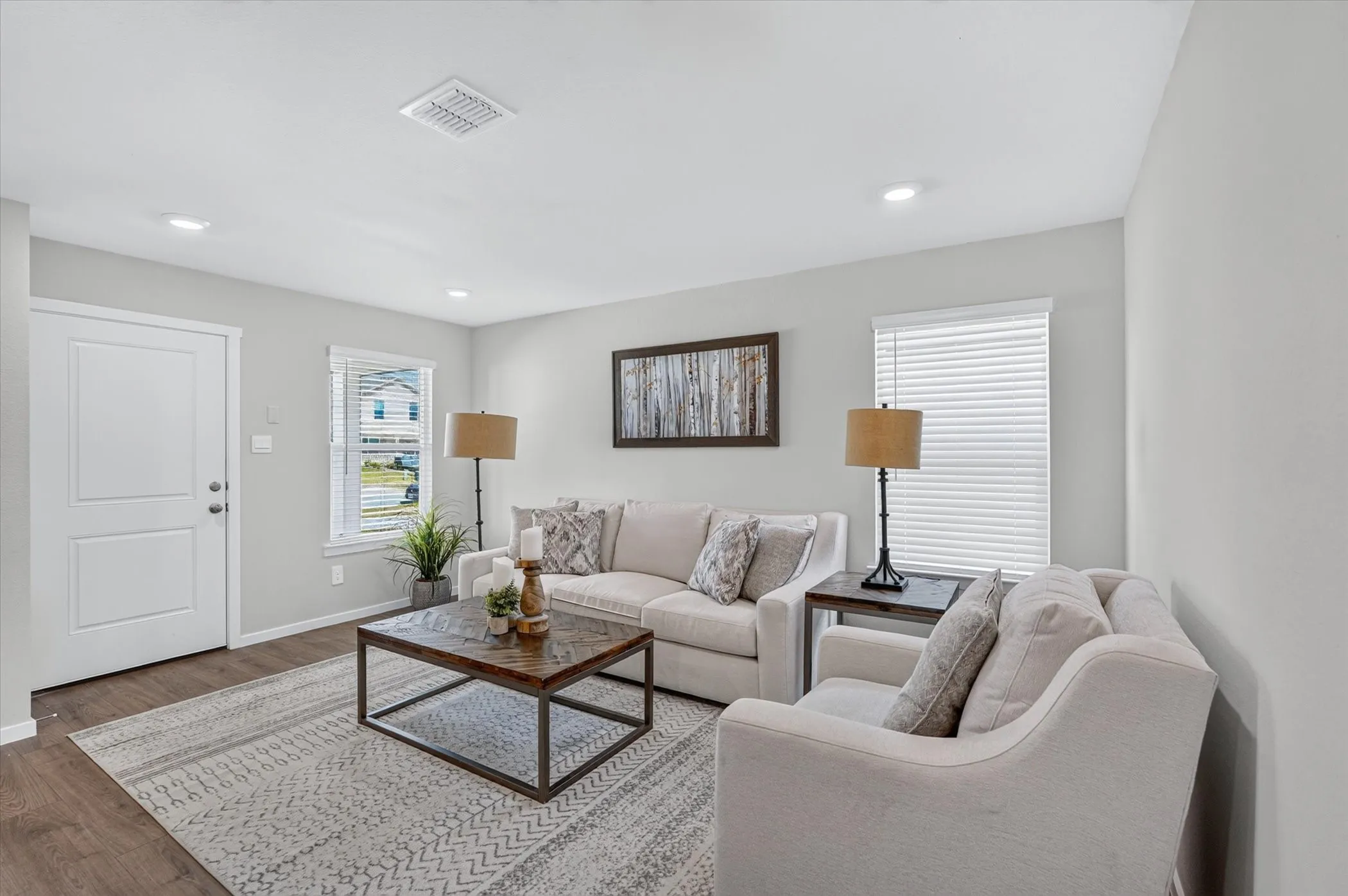 Recessed lighting, wood-finish flooring, and white interior doors