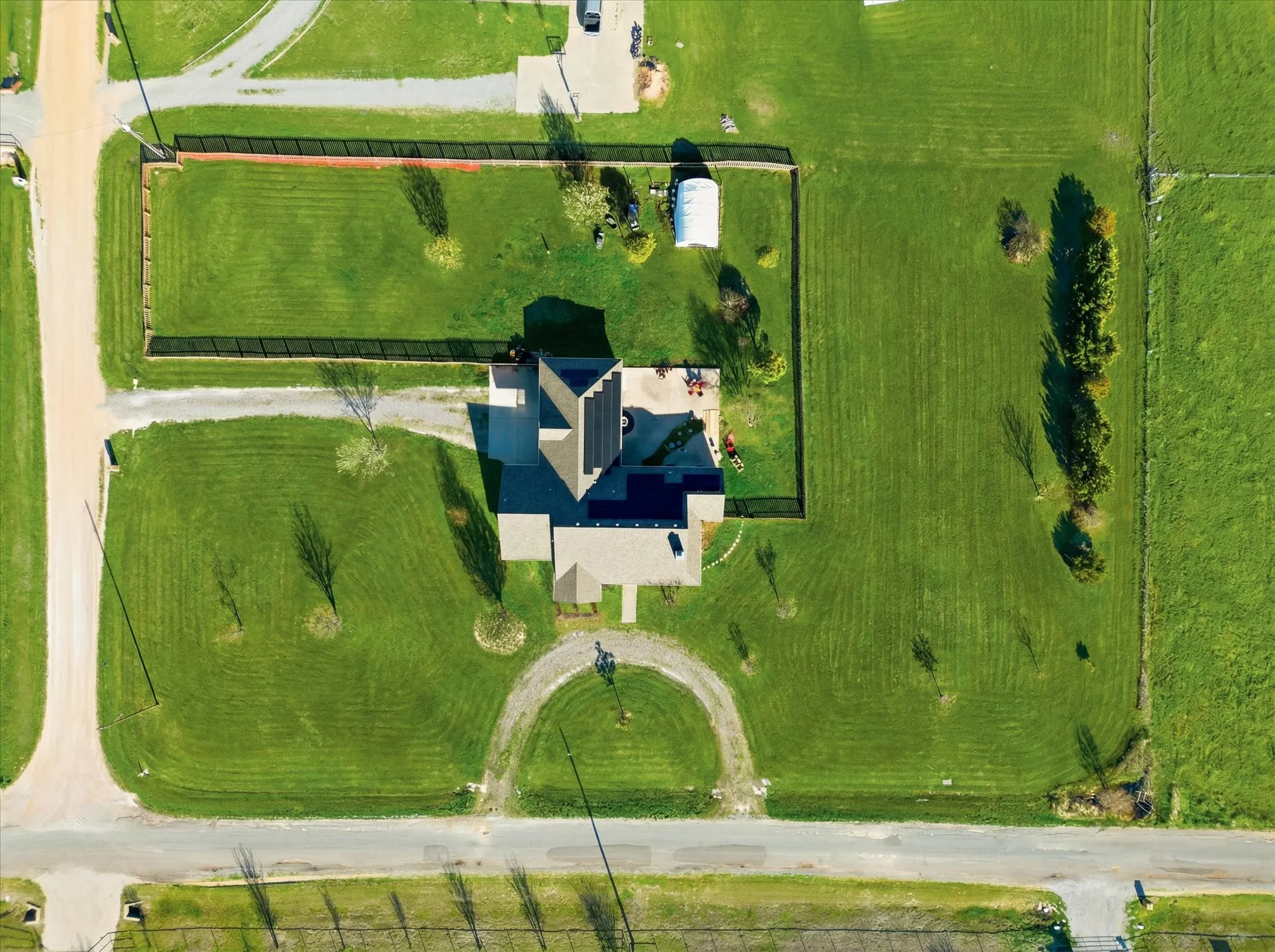 Aerial perspective showcasing a property with extensive green space