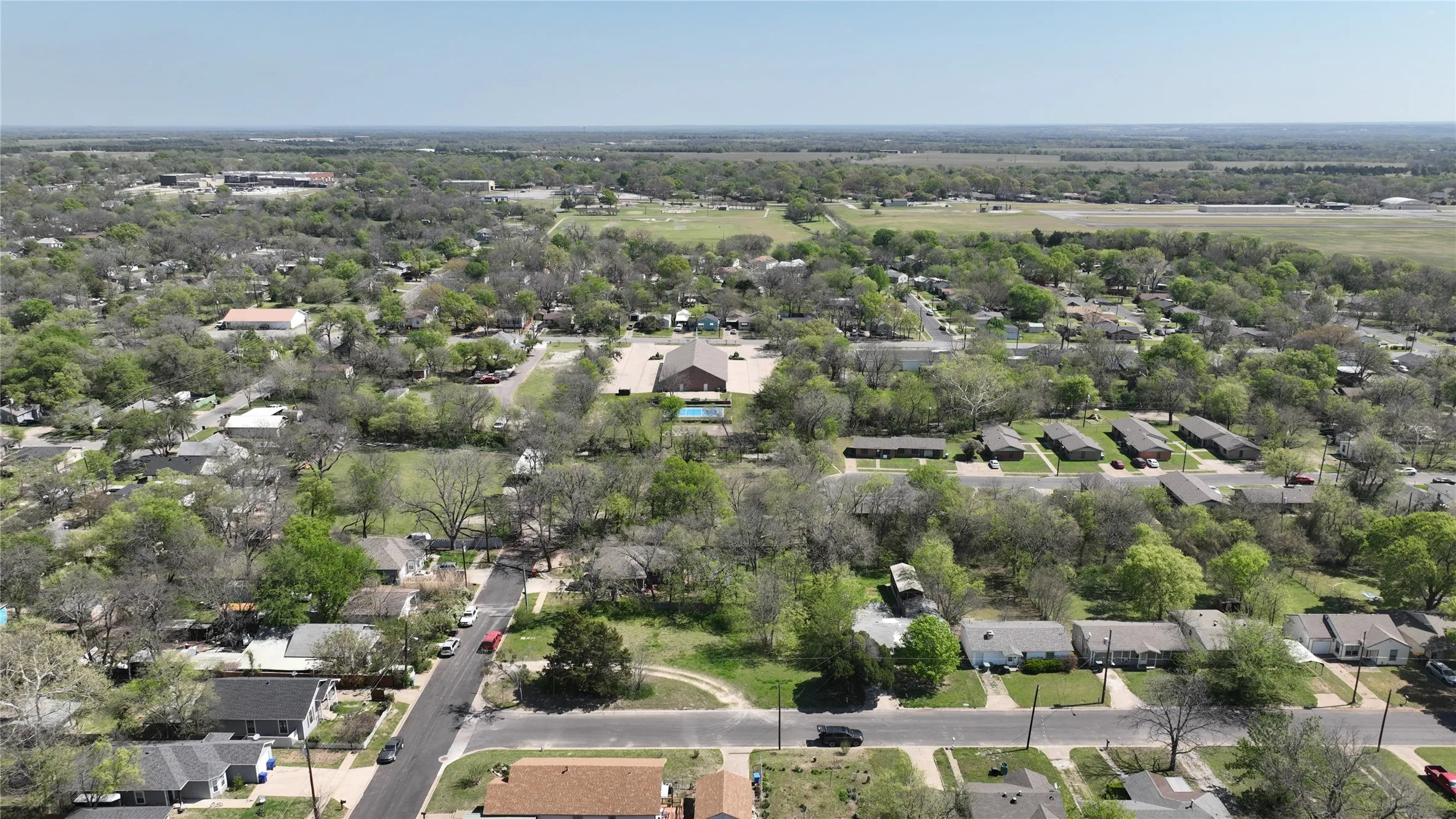 Aerial view of property's location featuring nearby suburban area