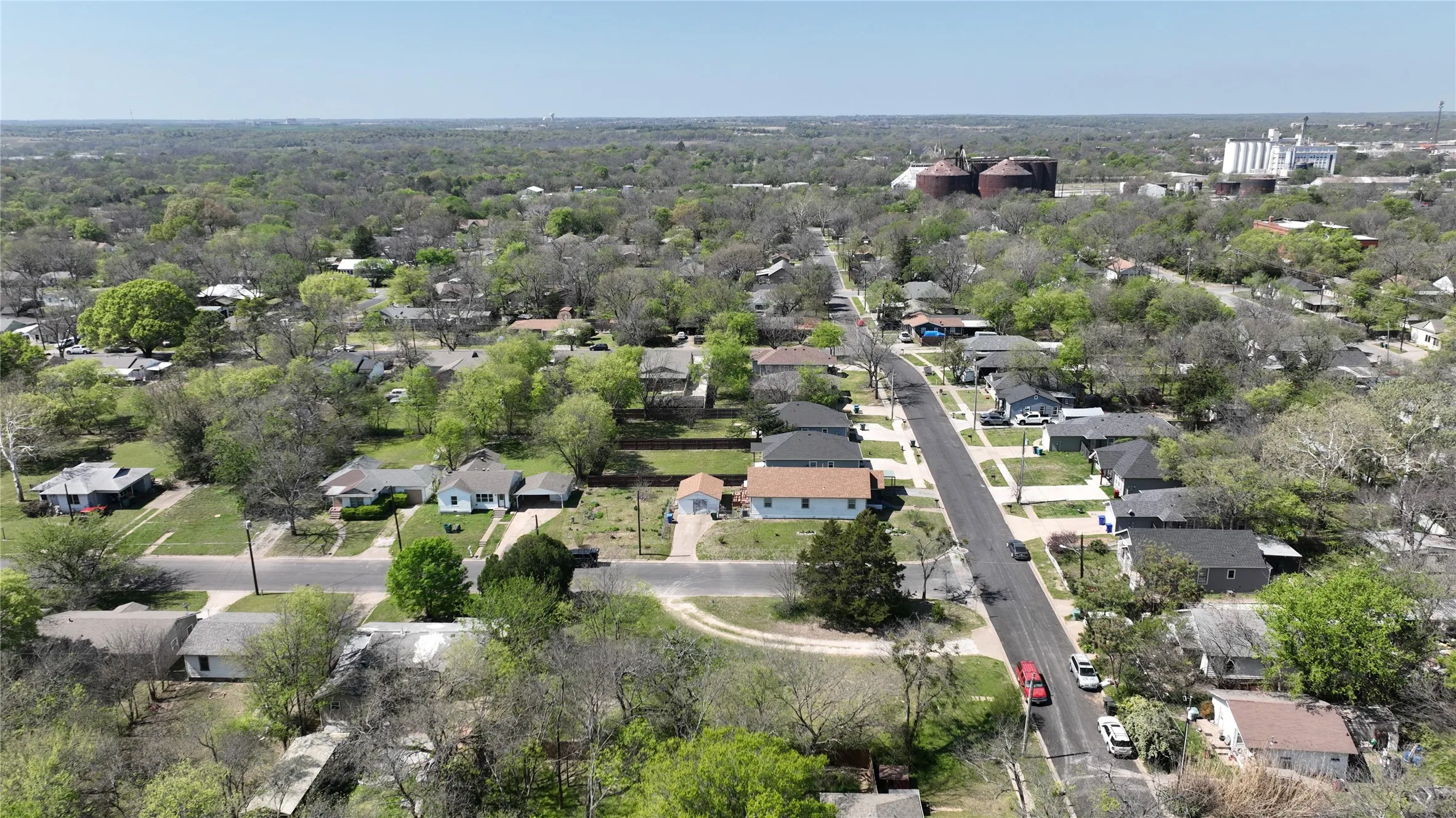 Aerial perspective of suburban area featuring a forest