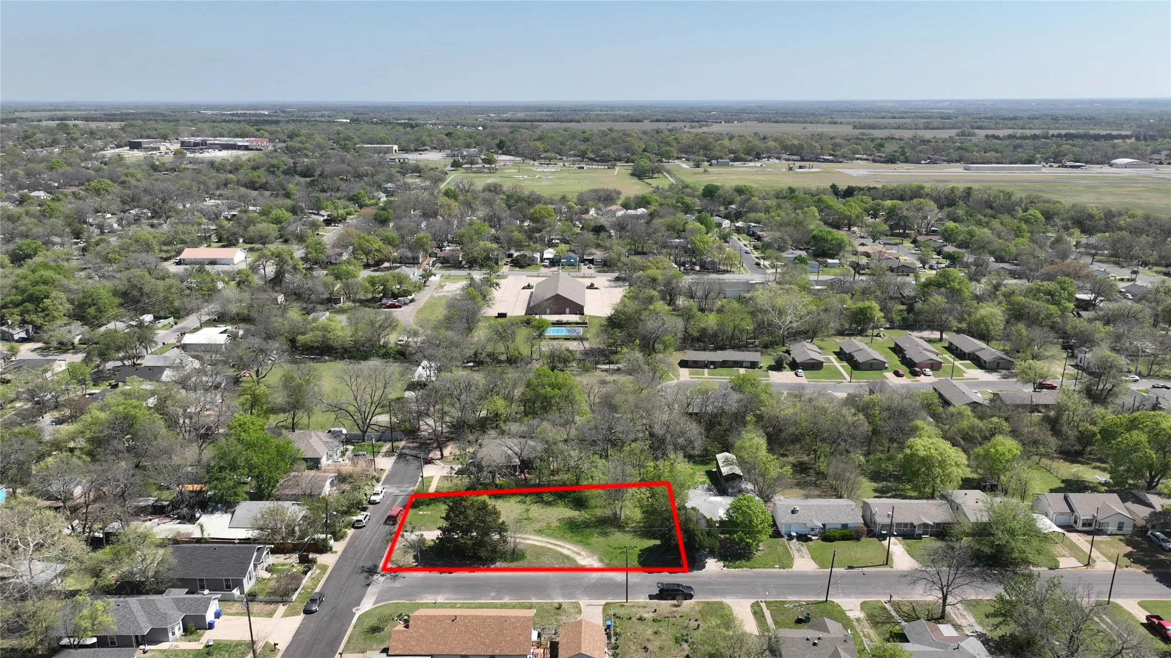 Aerial view of residential area featuring property boundaries highlighted