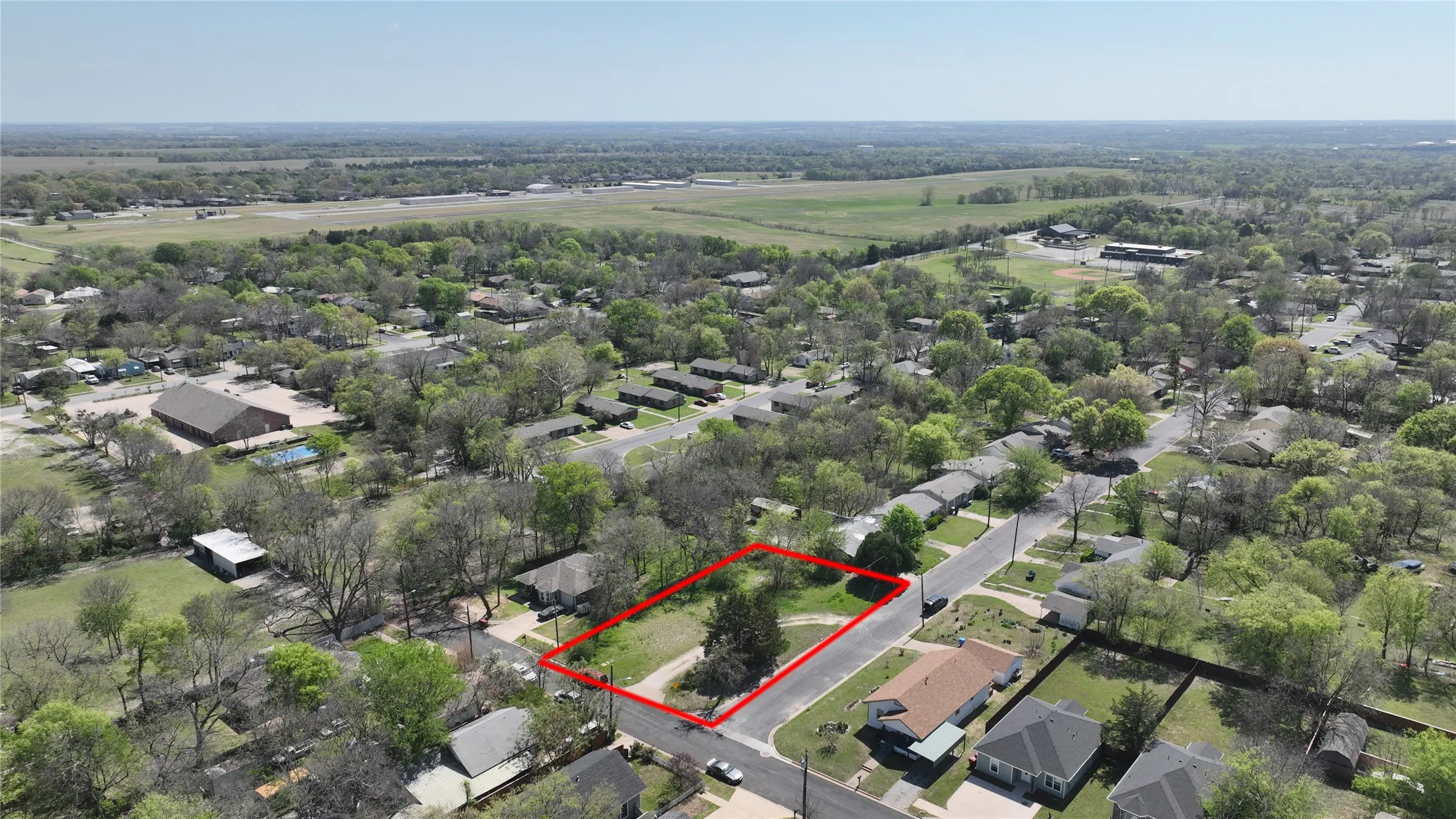 Aerial perspective of suburban area featuring property boundaries highlighted