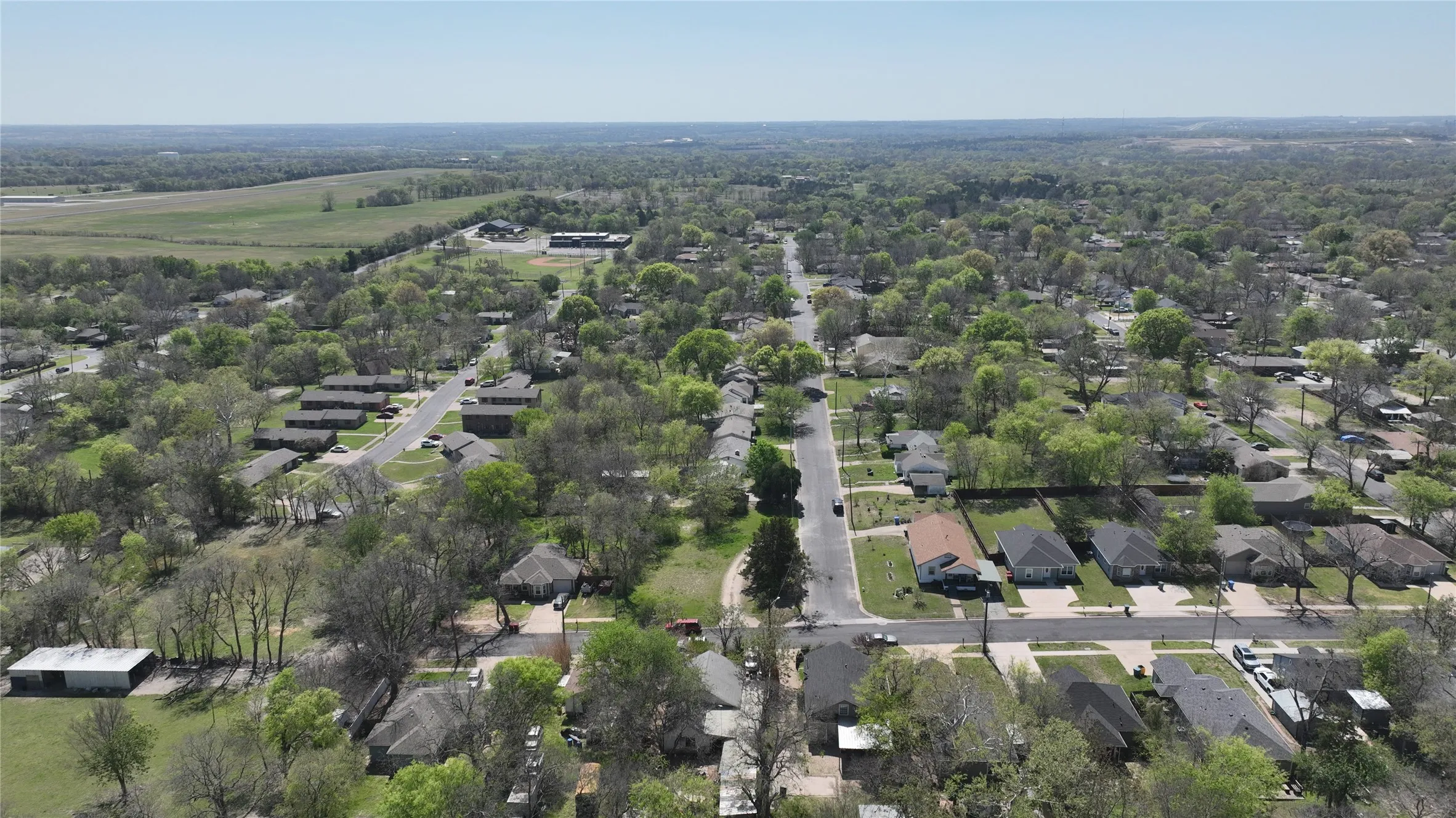 Aerial view of property's location featuring nearby suburban area
