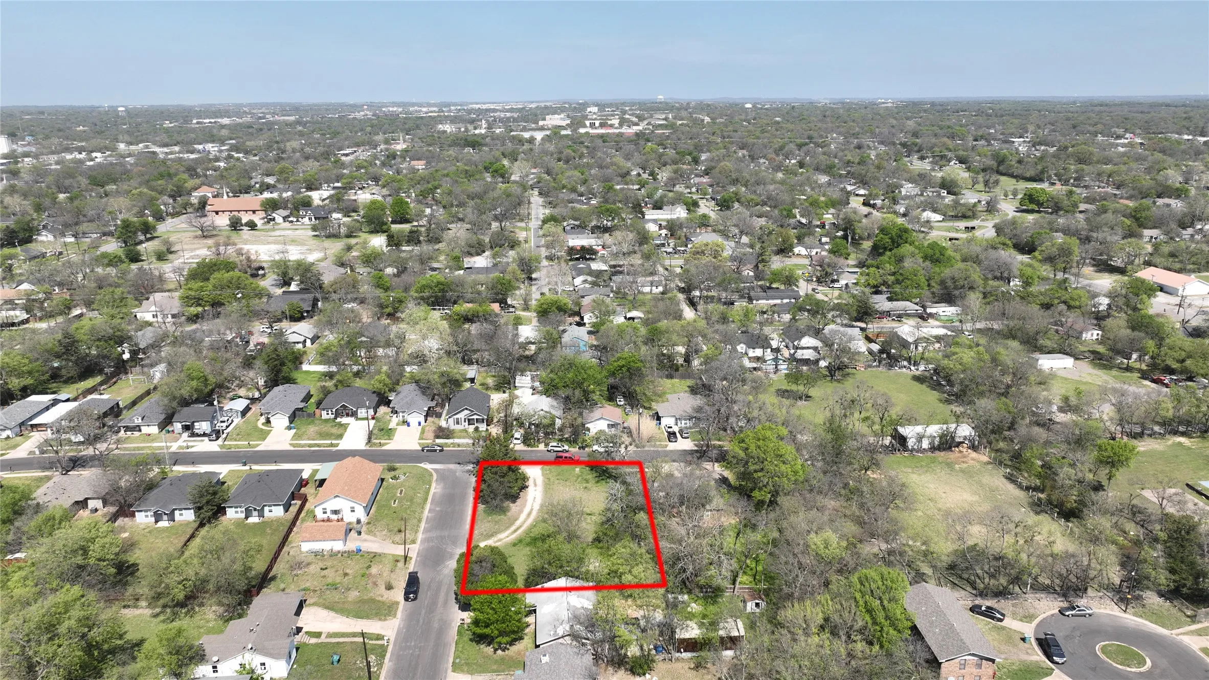 Aerial view of residential area with property boundaries highlighted