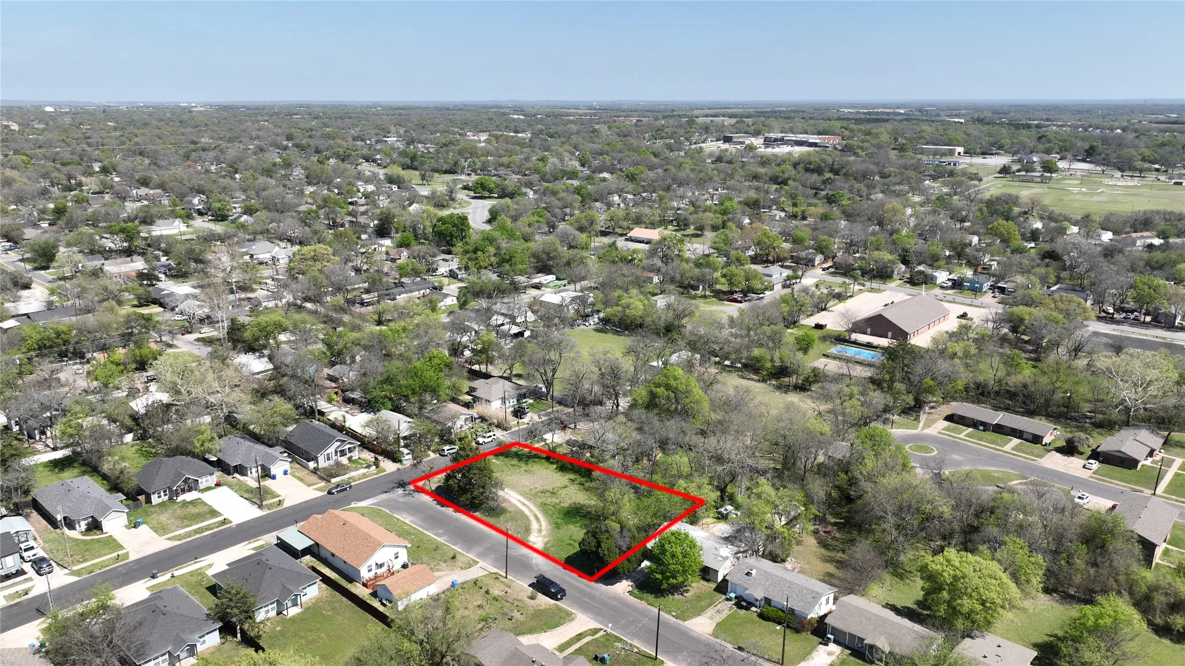 Aerial perspective of suburban area featuring property parcel outlined
