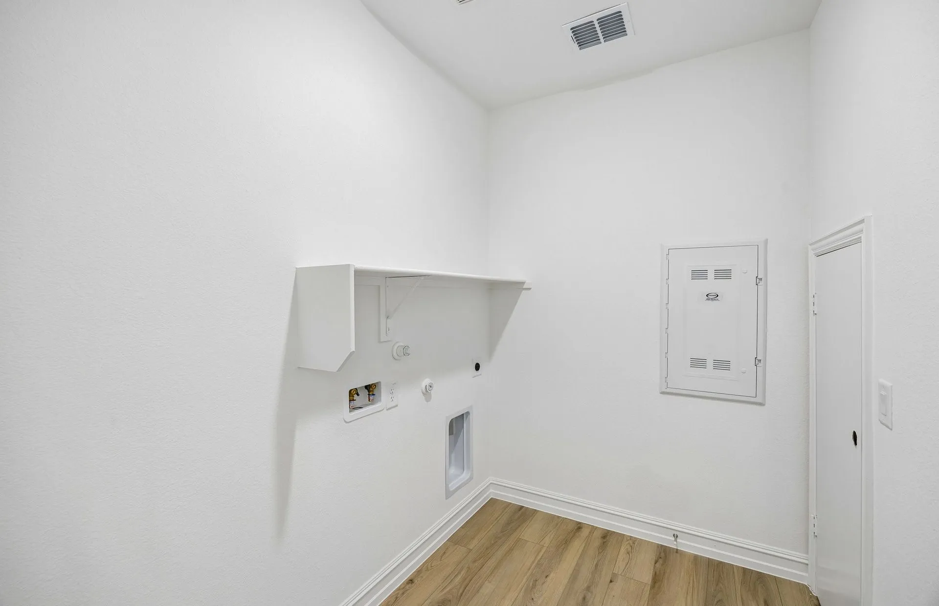 Laundry room with built-in shelving
