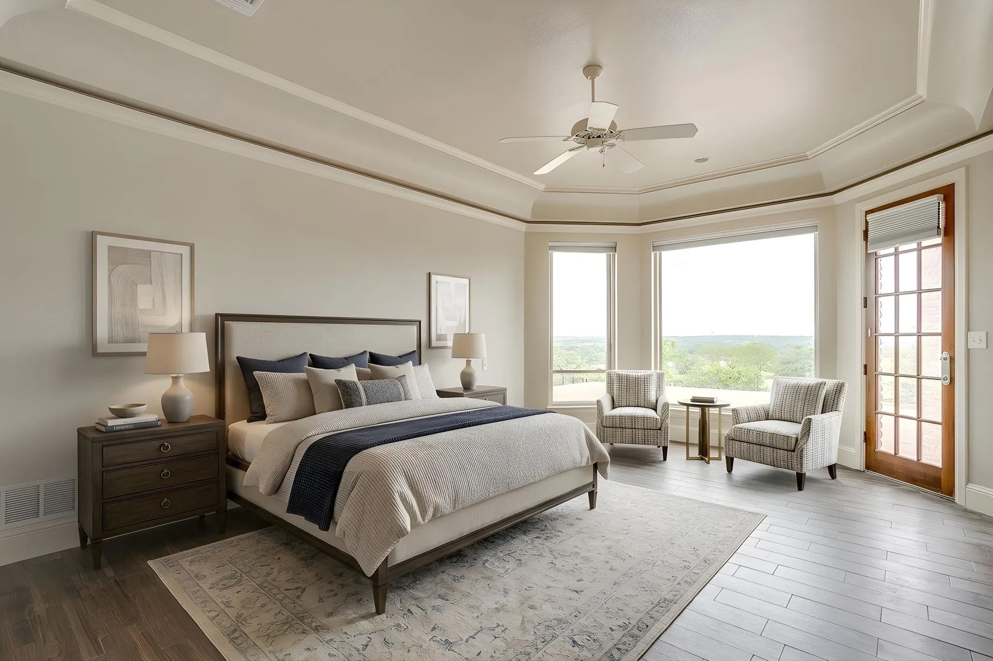 This room features a tray ceiling with a ceiling fan, large windows providing expansive views, and a glass-paneled door