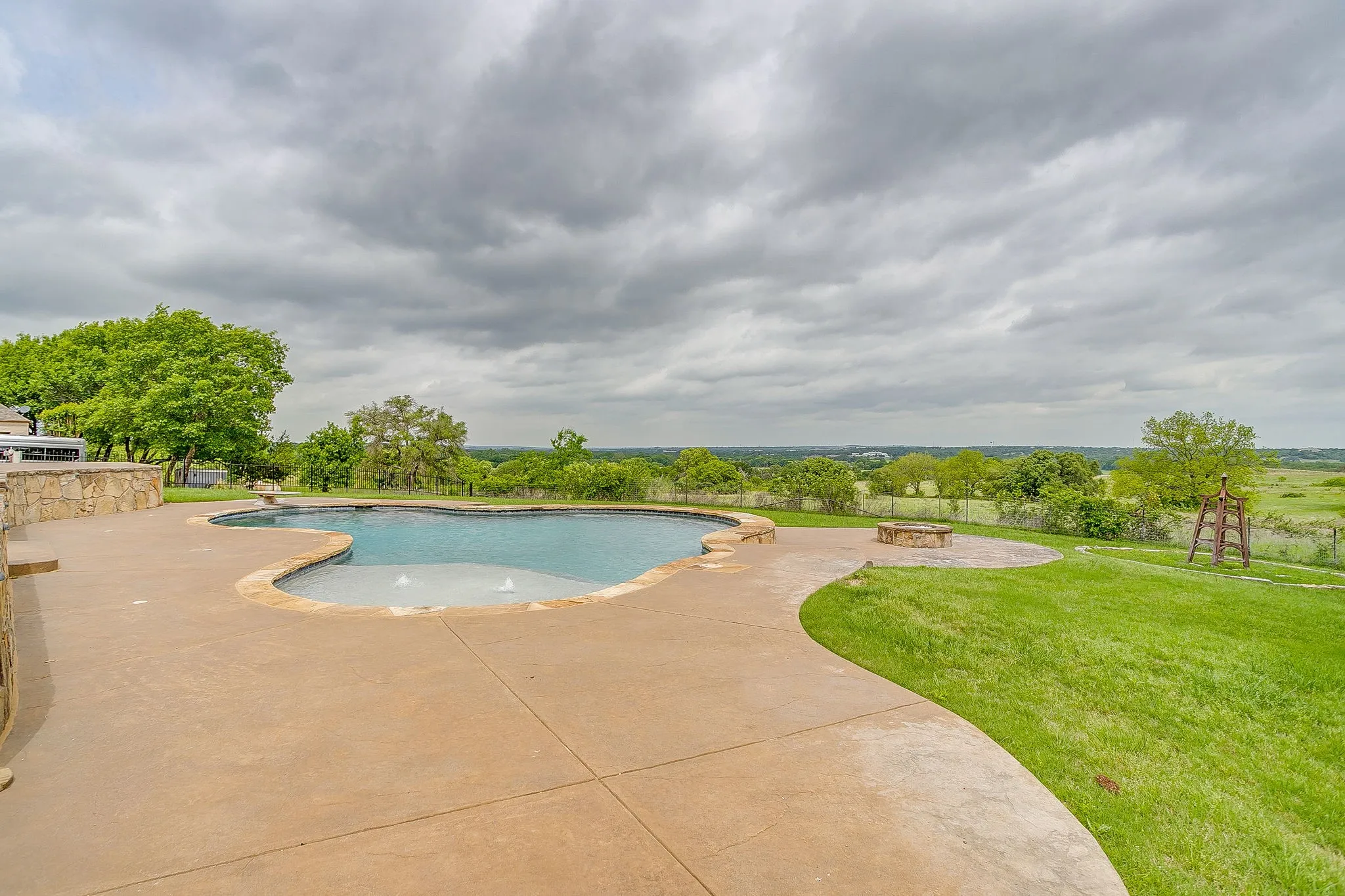 The property features an outdoor pool with a curved patio surround
