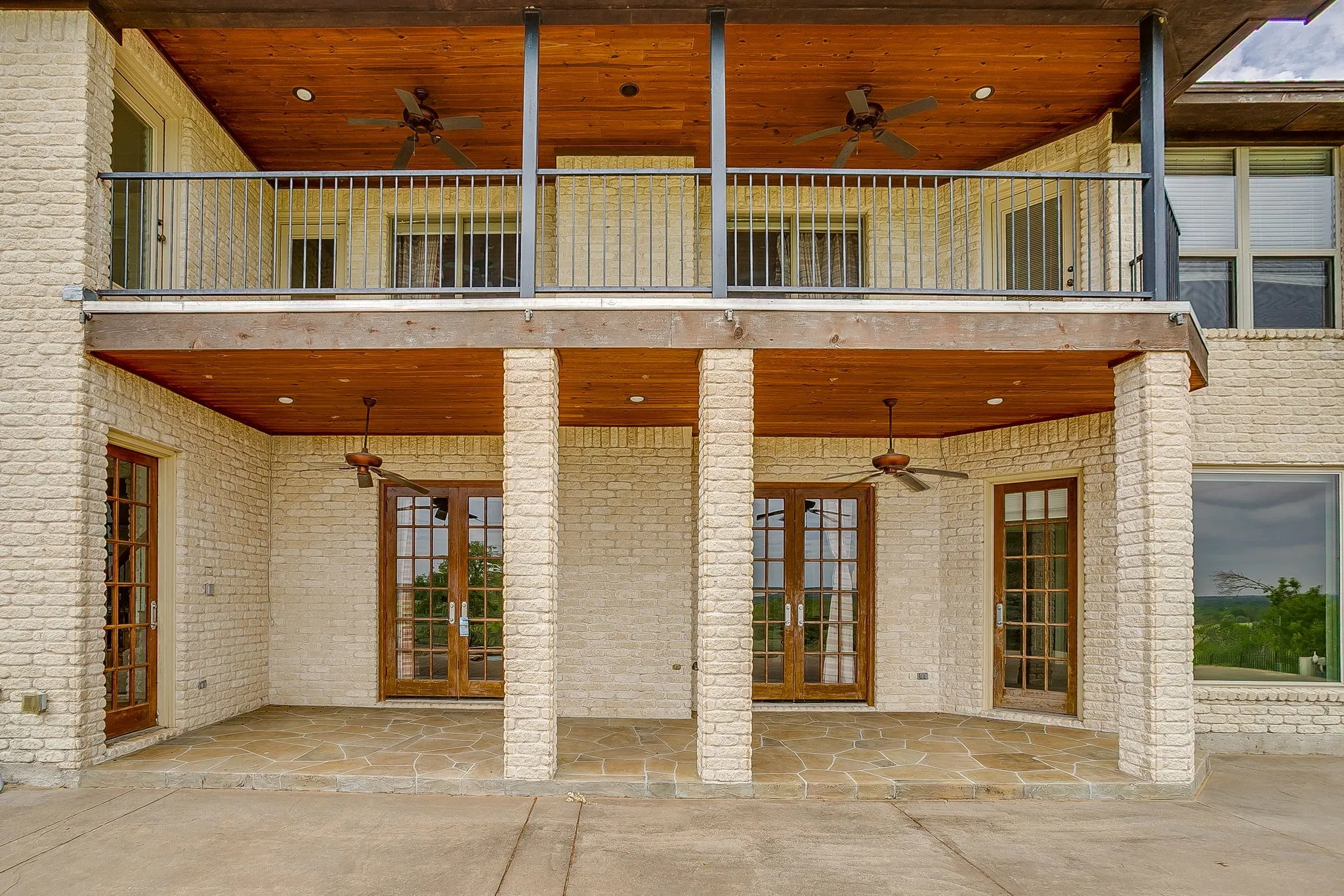 The property features a two-story exterior with a cream-colored brick facade