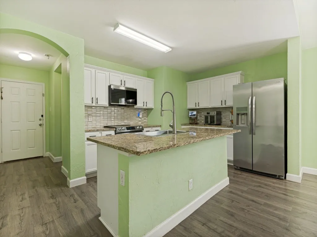 Tile backsplash, granite countertops, stainless steel appliances help create the space to create culinary magic and memories.