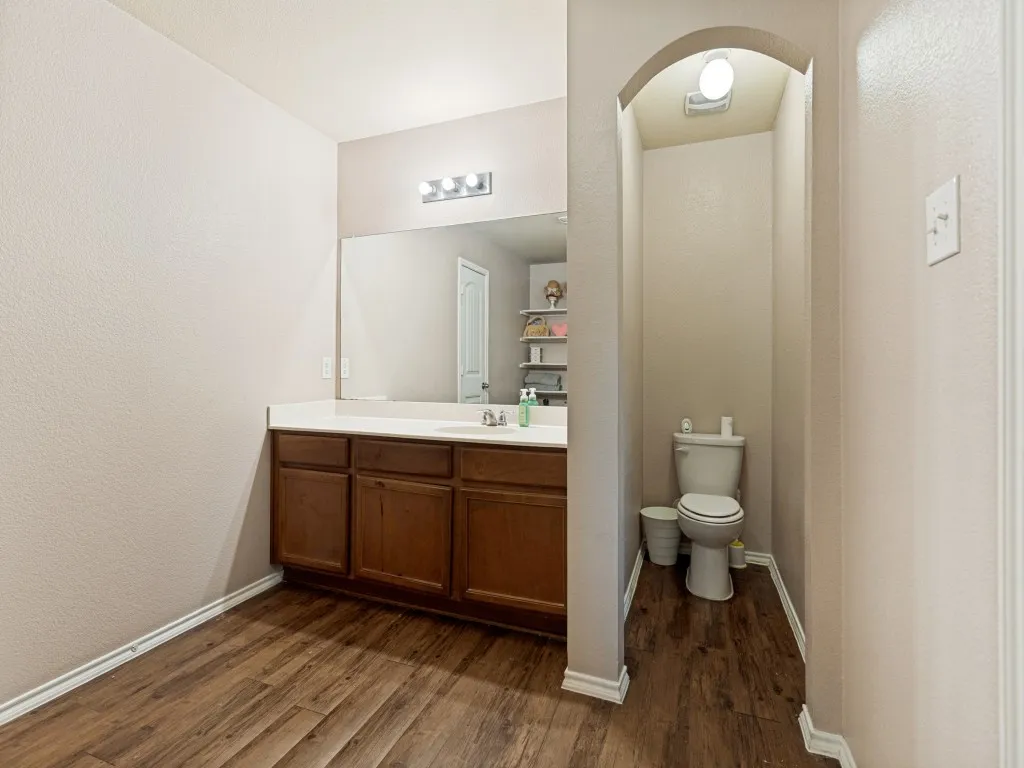 The spacious primary bath offers an oversized vanity with abundant counter space, providing plenty of room for busy mornings and everyday convenience.