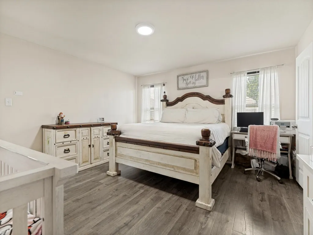 Another view of the spacious primary suite highlights ample room for oversized furniture, a workspace, nursery, or cozy reading nook—all complemented by abundant natural light and easy-care flooring.
