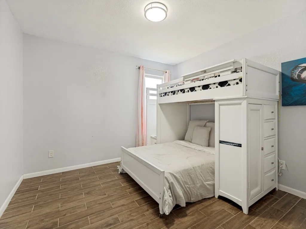 Bedroom #3 - Bright and versatile secondary bedroom with durable flooring, natural light, and plenty of space for family & guests.  Smooth flooring throughout makes for maintenance ease!