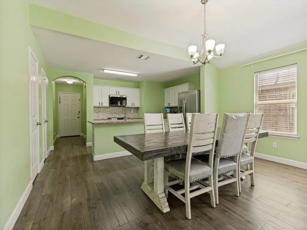 Spacious open dining area easily accommodates a large table, creating the perfect setting for family gatherings, celebrations, and everyday connection.