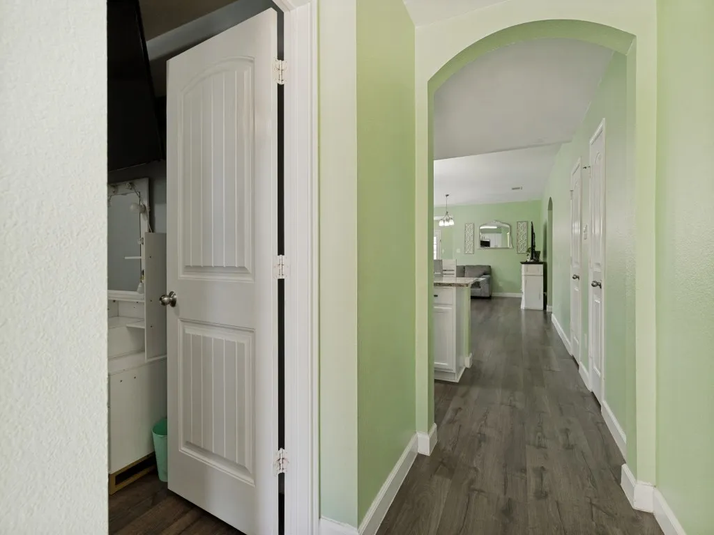 Welcoming hallway showcases the home's open layout, durable flooring, and easy flow between living, dining, and private spaces