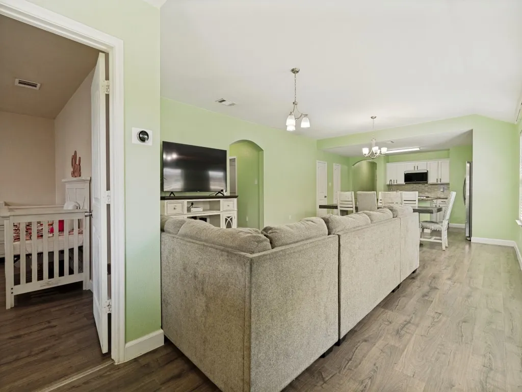 Sneak peek of the primary bedroom from the far end of the living area.