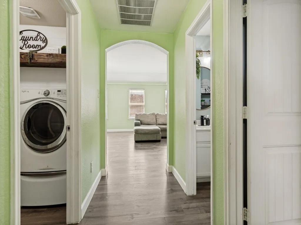 Thoughtfully designed hallway with convenient laundry access and a seamless flow connecting the home's private and gathering spaces.