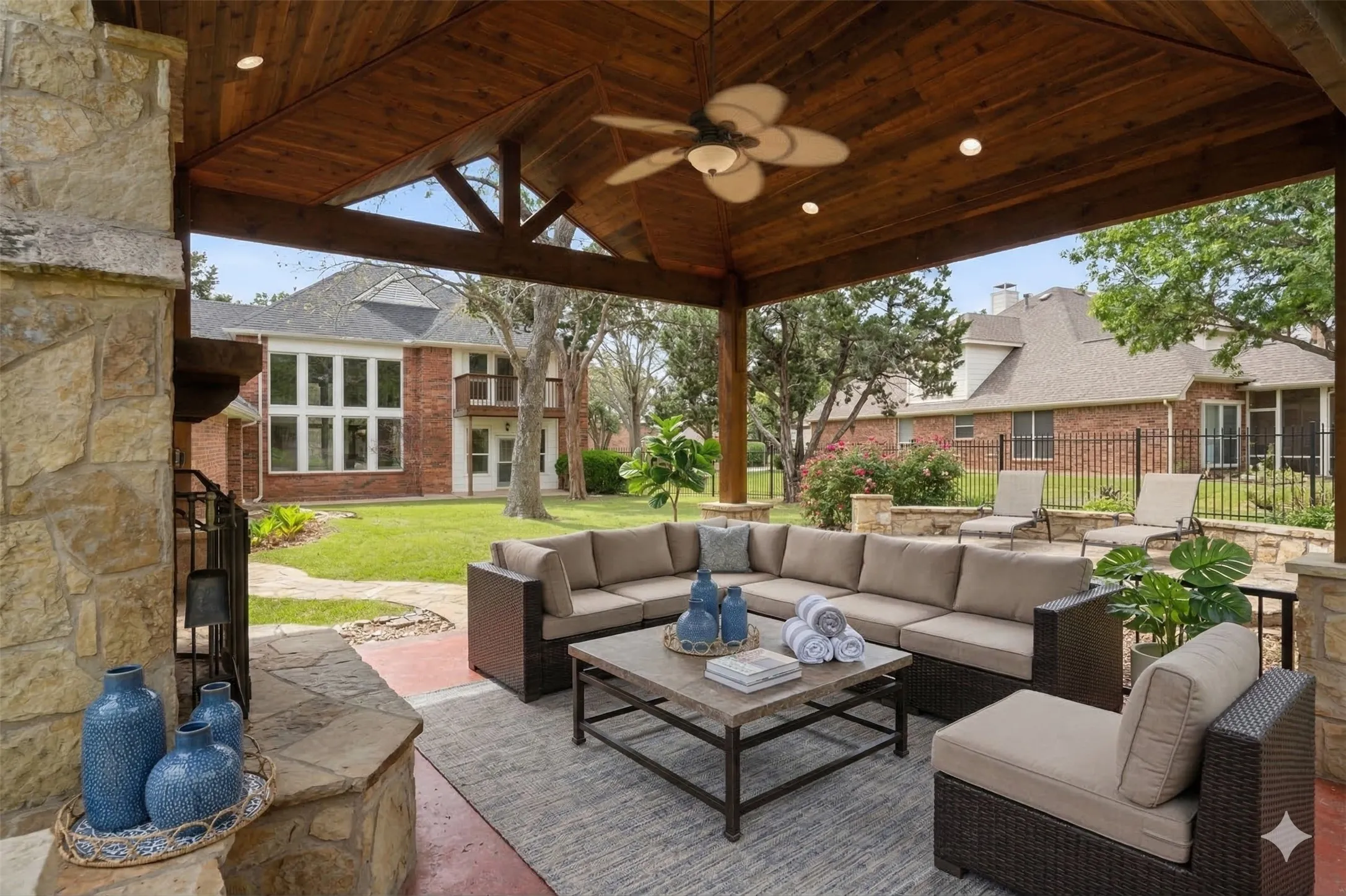 Virtually staged for context. large covered patio with fireplace and furniture