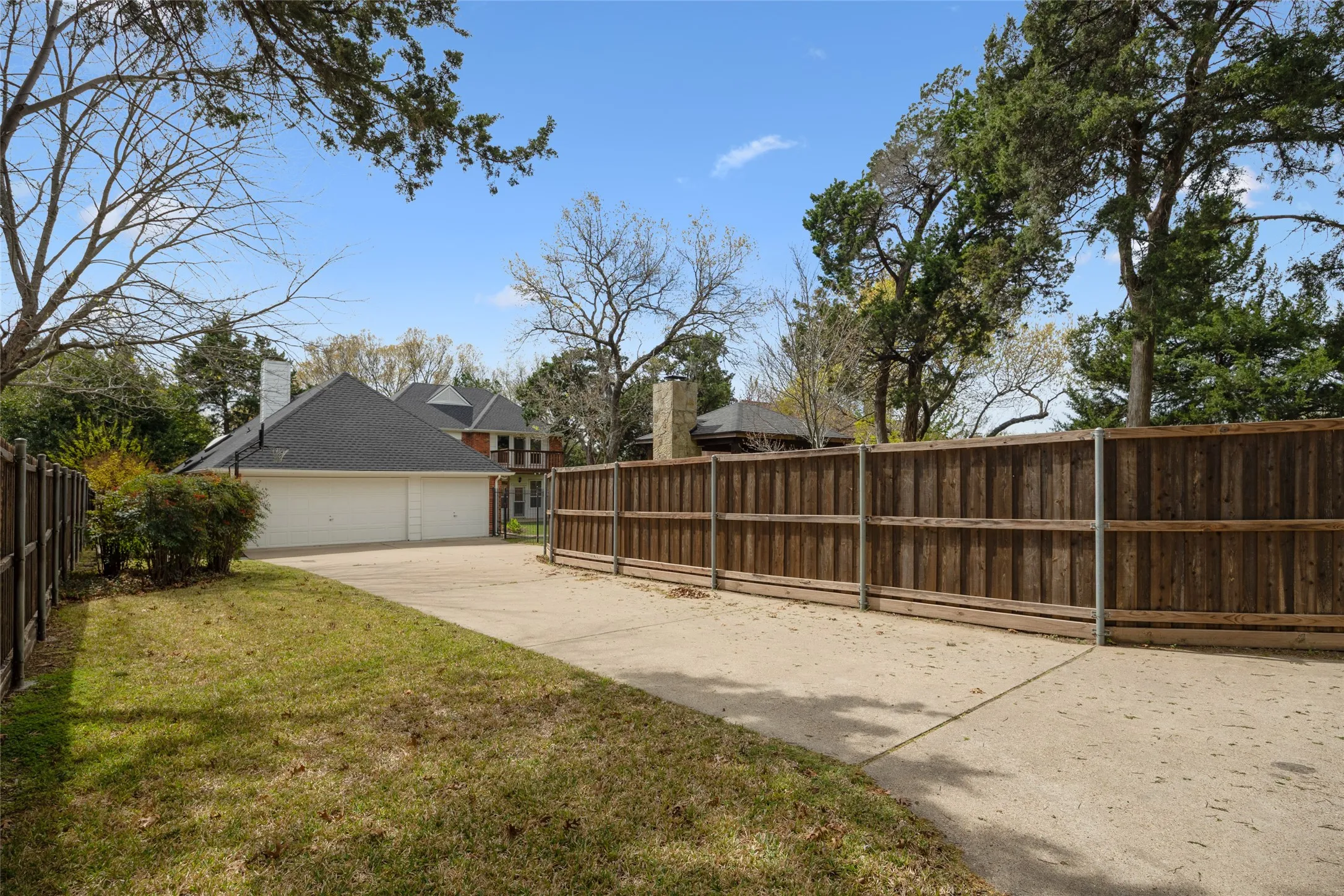 Fenced yard featuring driveway