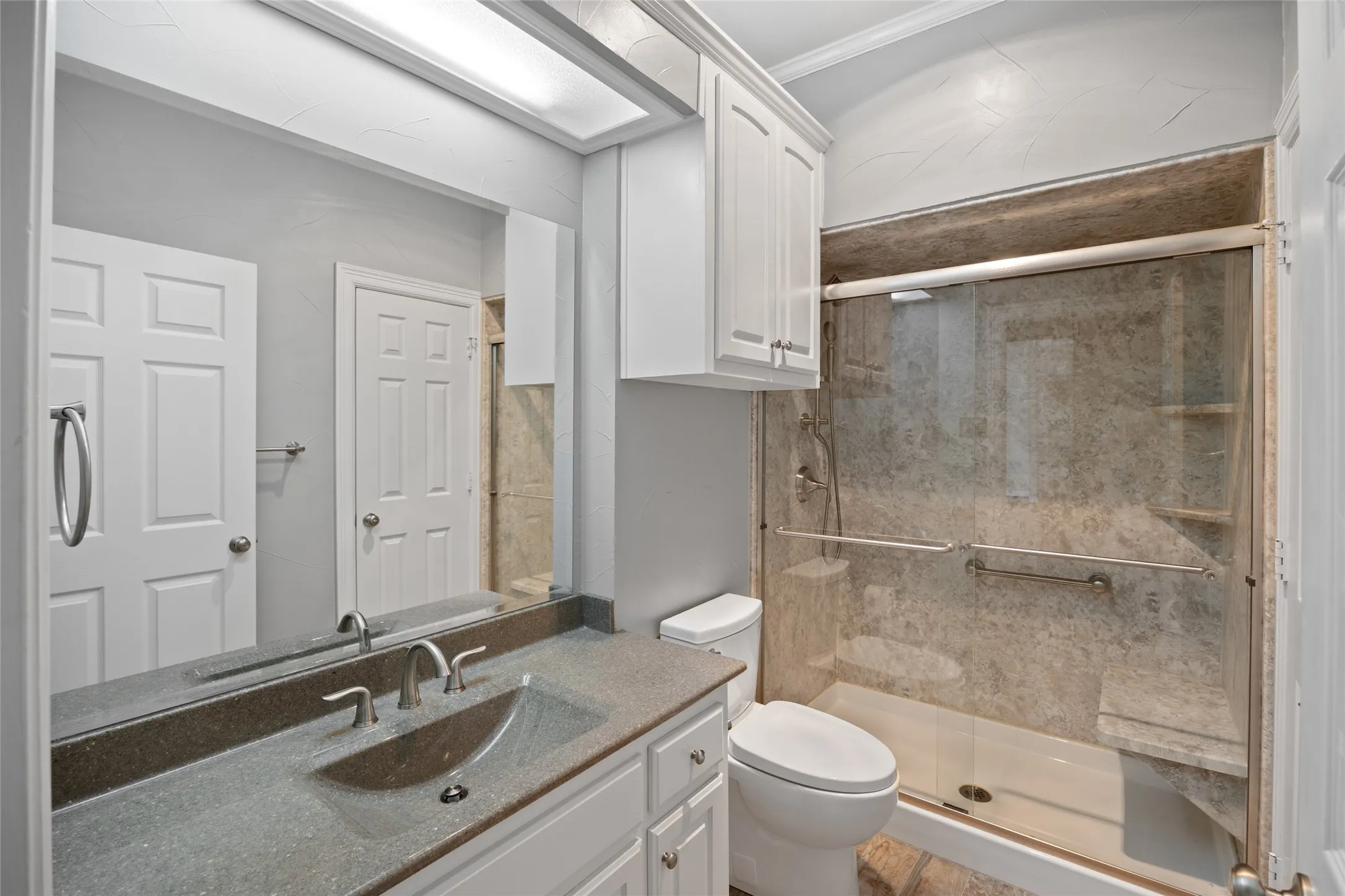 Full bath featuring vanity and a shower stall