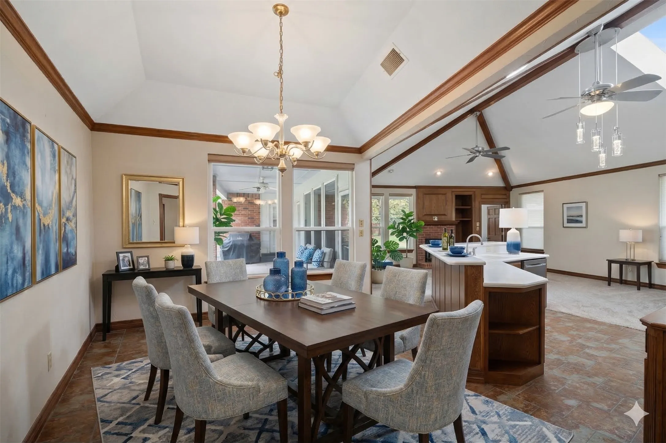 Virtually staged for context of space.  Breakfast area featuring ceiling fan, lofted ceiling, dark stone finish flooring, light fixtures and ornamental molding, great open space with wonderful views of the backyard spaces.
