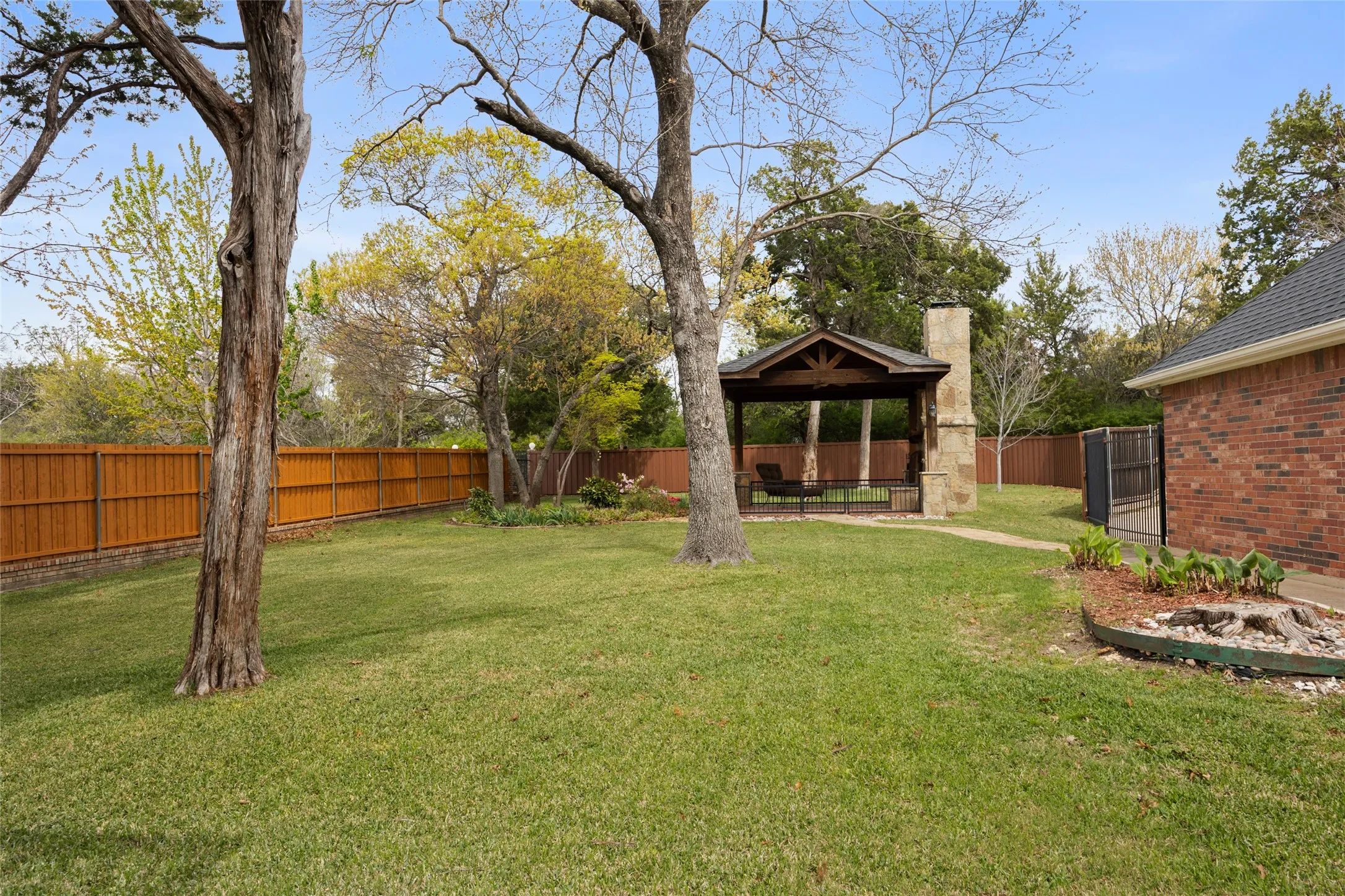 Fenced backyard featuring a patio