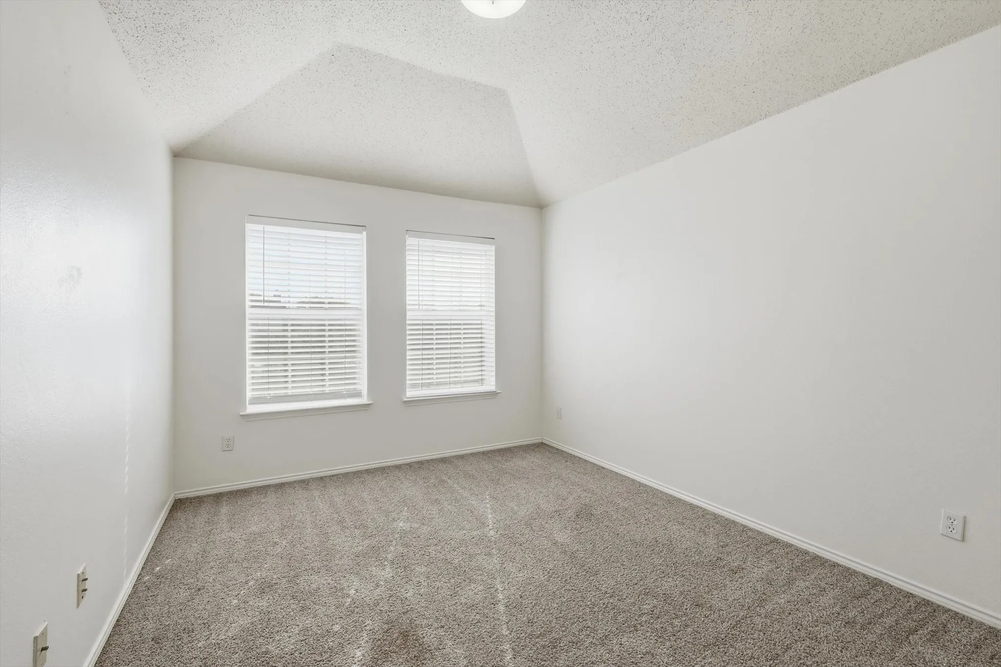 Carpeted spare room with baseboards