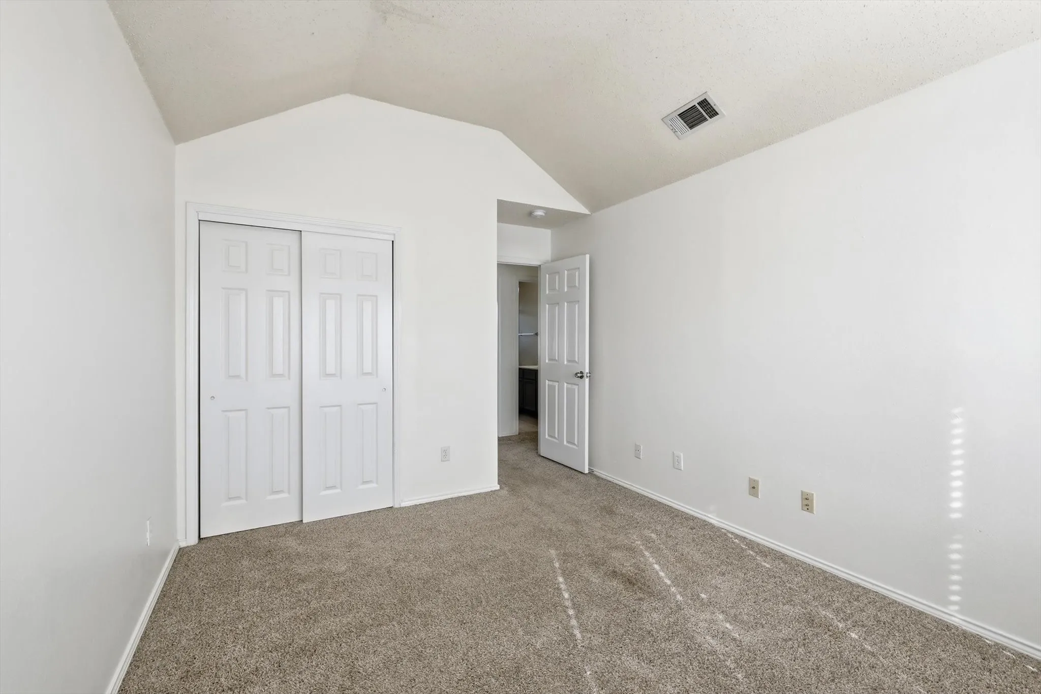 Unfurnished bedroom with carpet and a closet