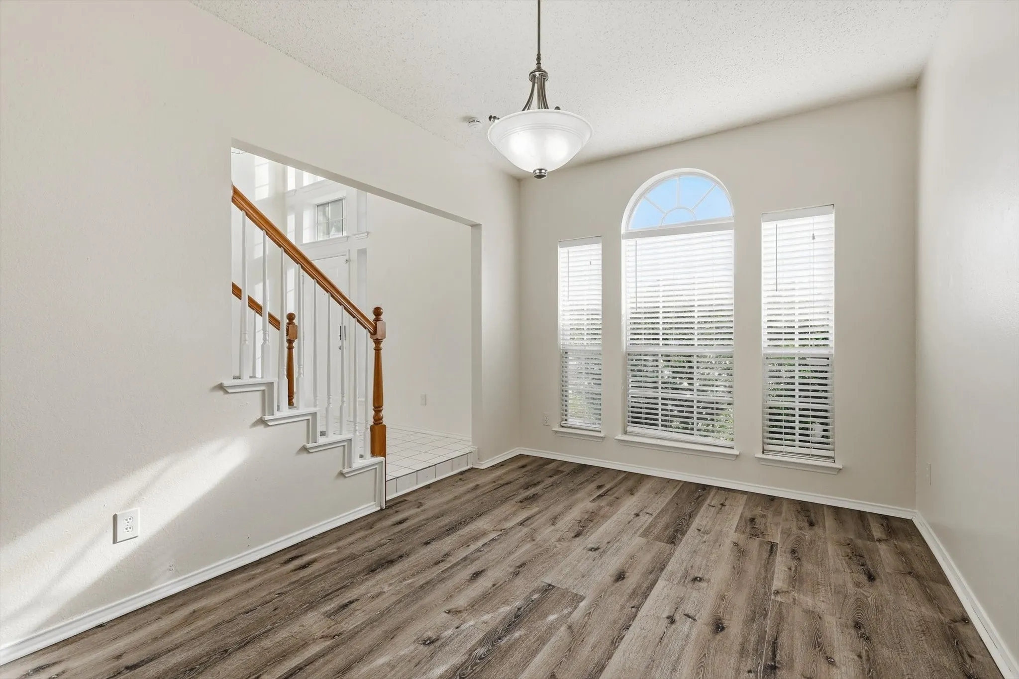 Foyer entrance with wood finished floors and a textured ceiling