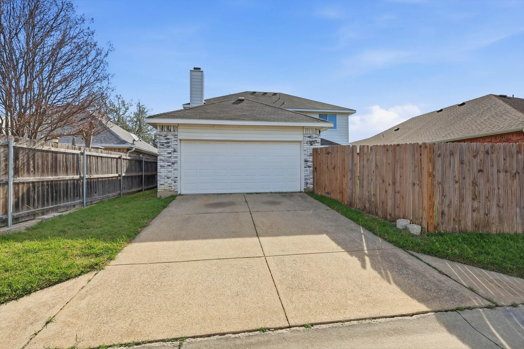 Garage featuring concrete driveway