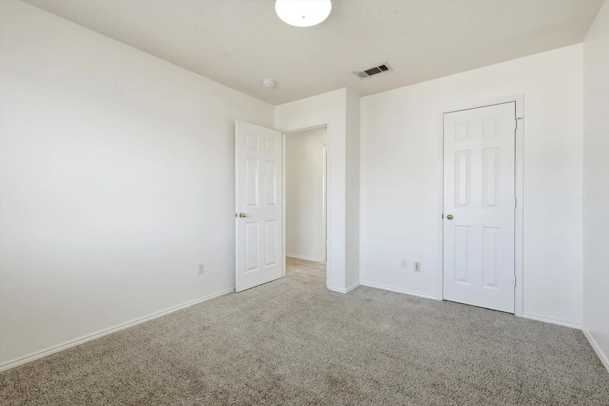 Unfurnished bedroom featuring carpet and baseboards