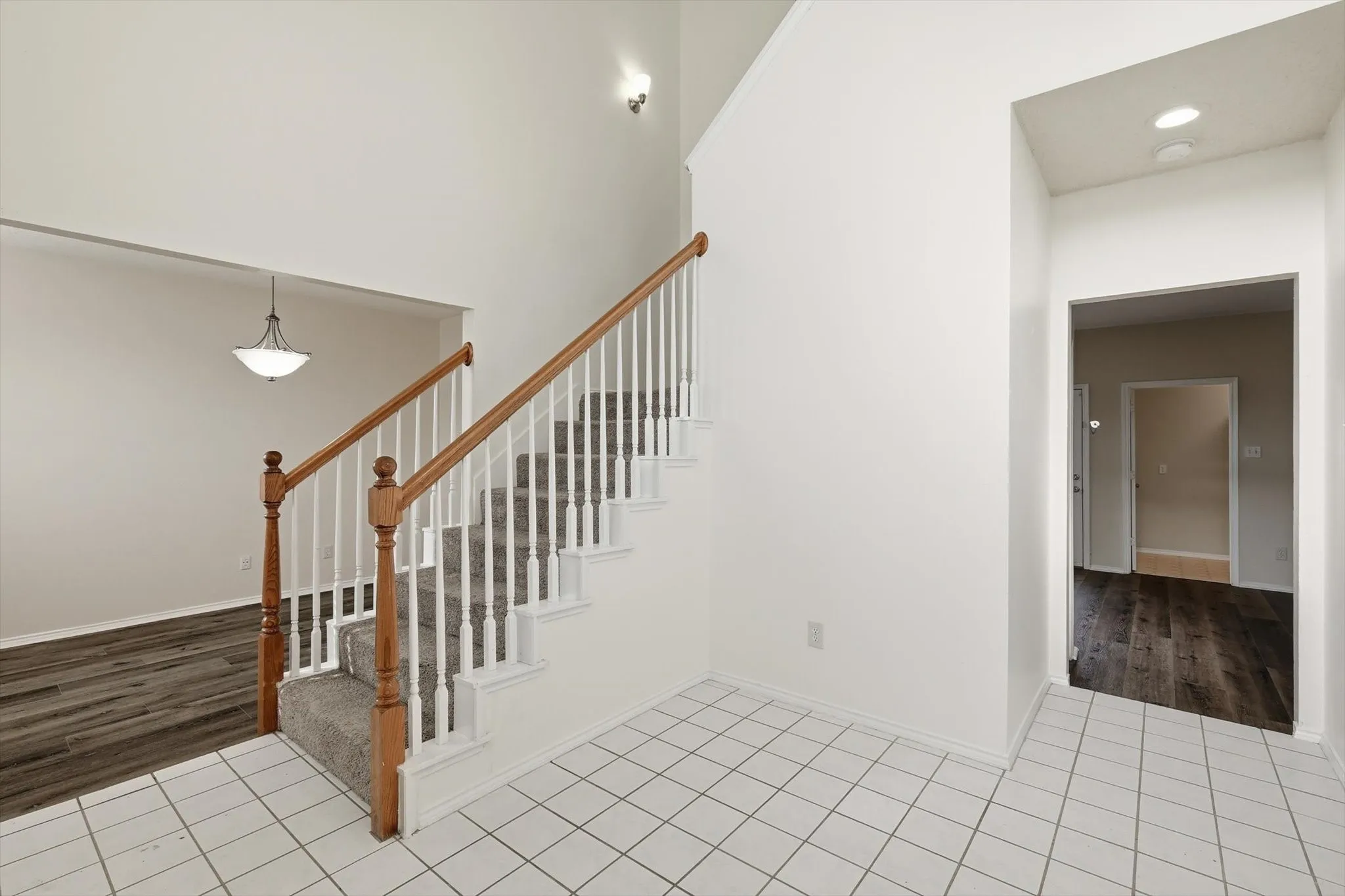 Stairway featuring tile patterned floors and recessed lighting